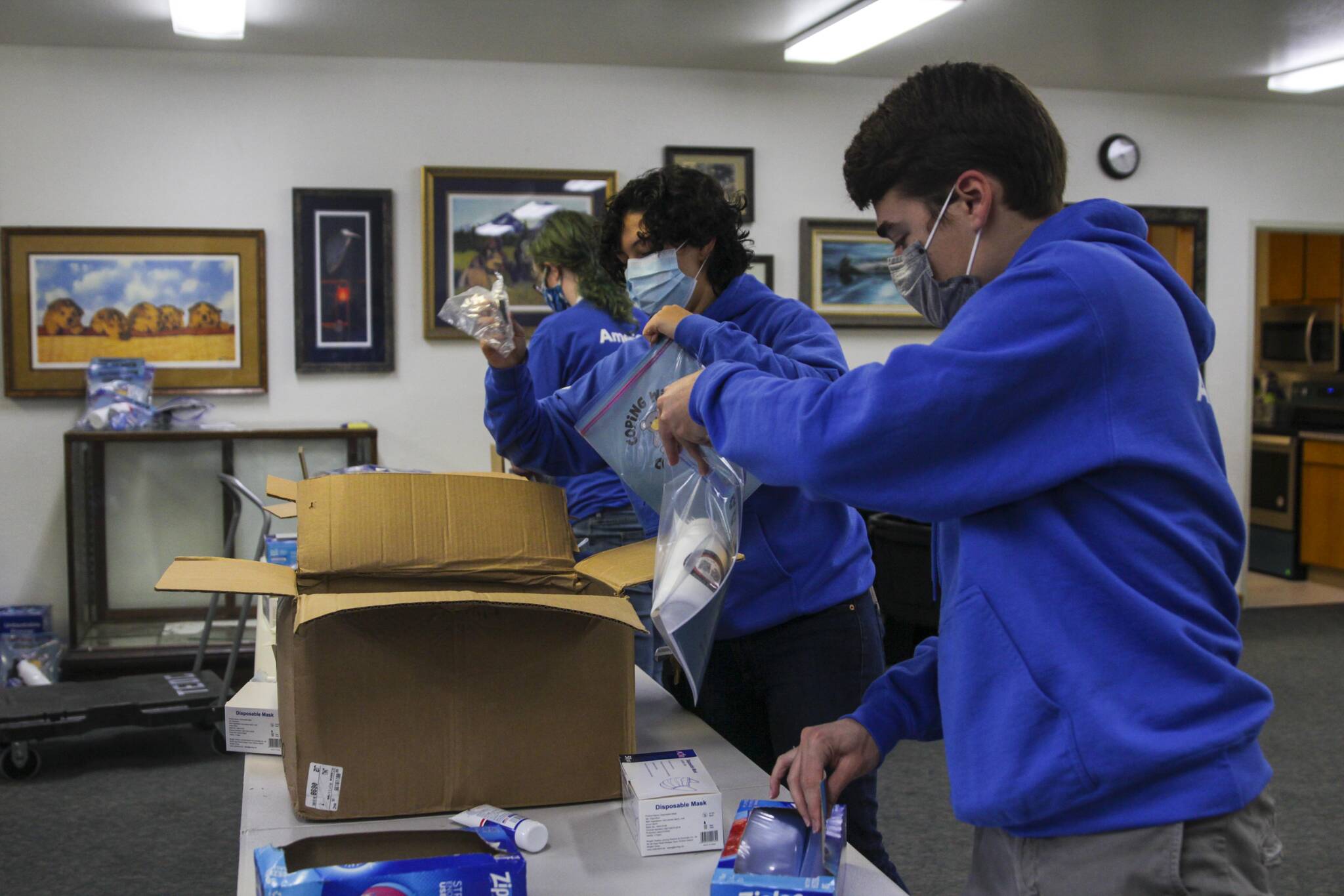 AmeriCorps members pack emergency preparedness kits for Central Council of Tlingit and Haida Indian Tribes of Alaska’s Tribal Emergency Operations Center as part of a day of service on Sept. 10, 2021. (Michael S. Lockett / Juneau Empire)