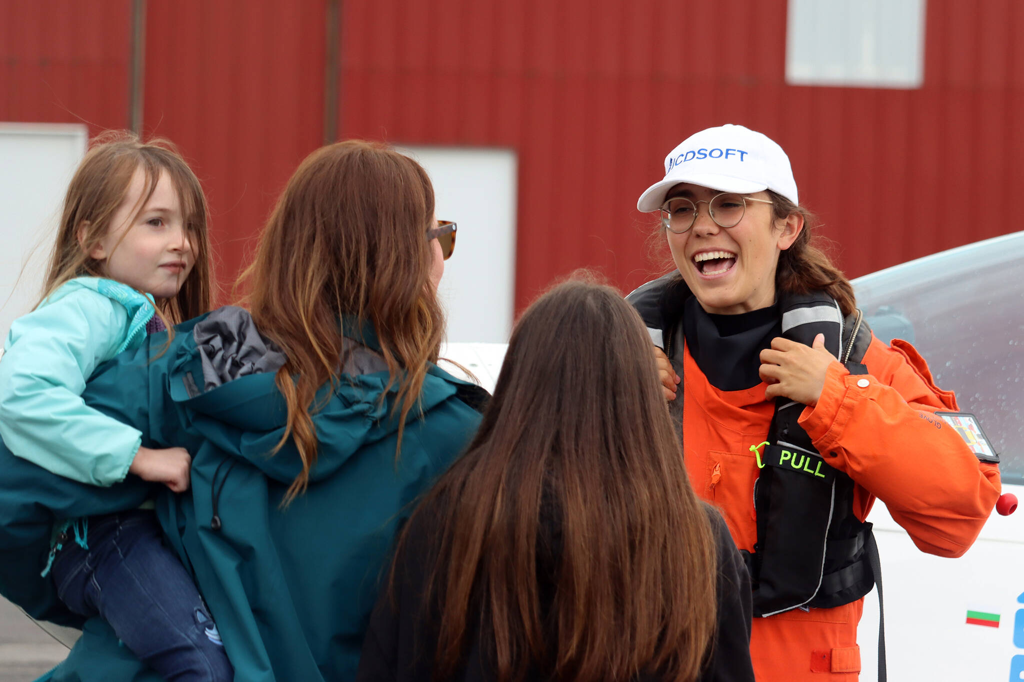 Adelynn, Heather and Aubrie Engen talk with Zara Rutherford at Ward Air on Saturday. Rutherford, who is pursuing a Guinness world record for youngest woman to fly solo around the world, took time to talk to people, take photos and sign autographs after landing in Juneau.(Ben Hohenstatt / Juneau Empire)