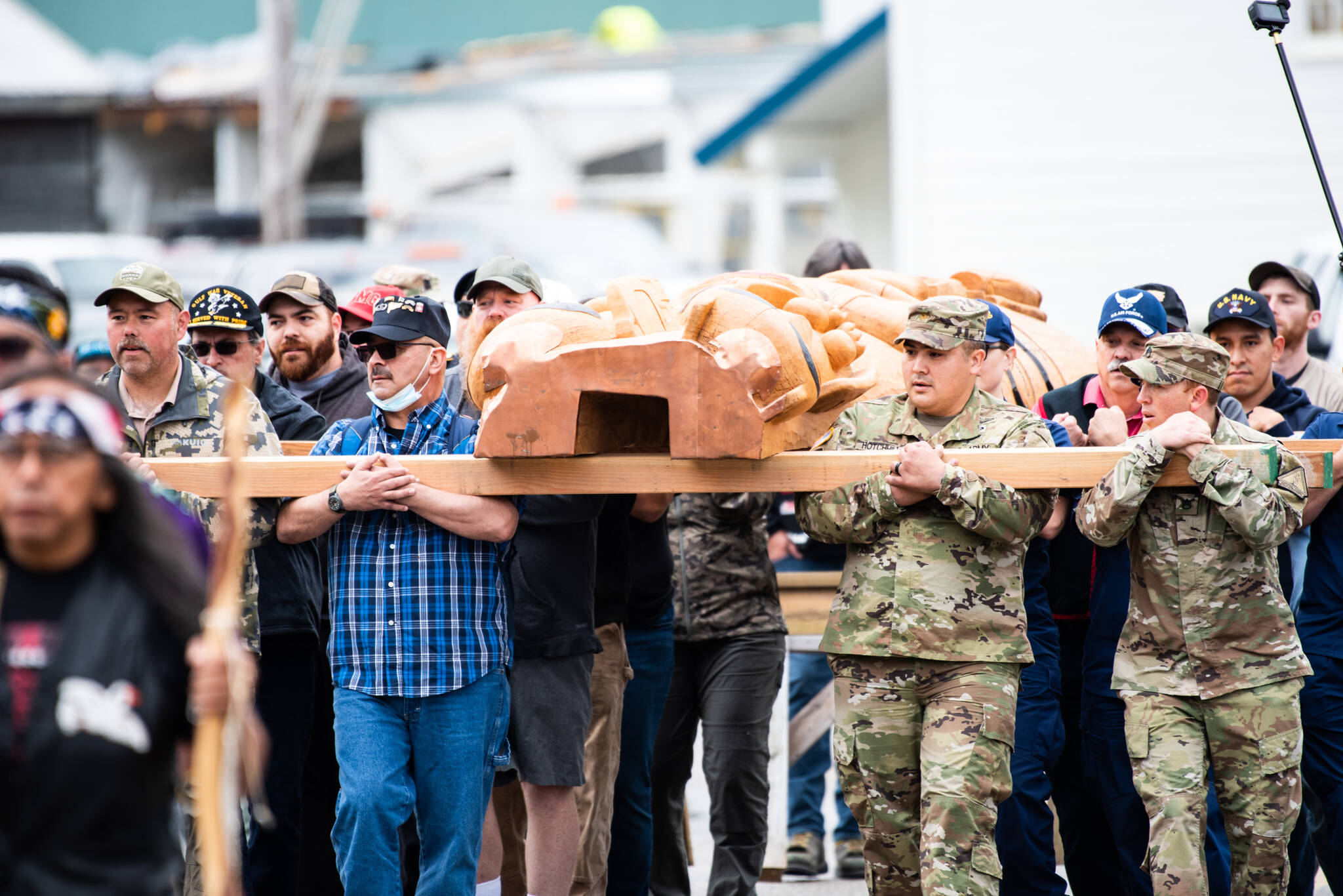 Veterans carry a totem pole before it is erected in Hoonah. In July, hundreds attended a ceremony at the Southeast Alaska village. The totem pole honors the contributions of Alaska Natives in many U.S. conflicts. (Courtesy Photo / Ian Johnson)