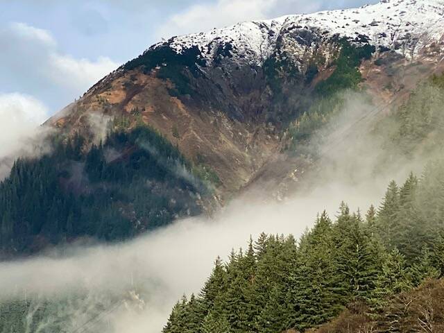 A low cloud nestles between snow-capped Mt. Juneau and Mt. Roberts on Oct. 26, 2021. (Courtesy Photo / Denise Carroll)