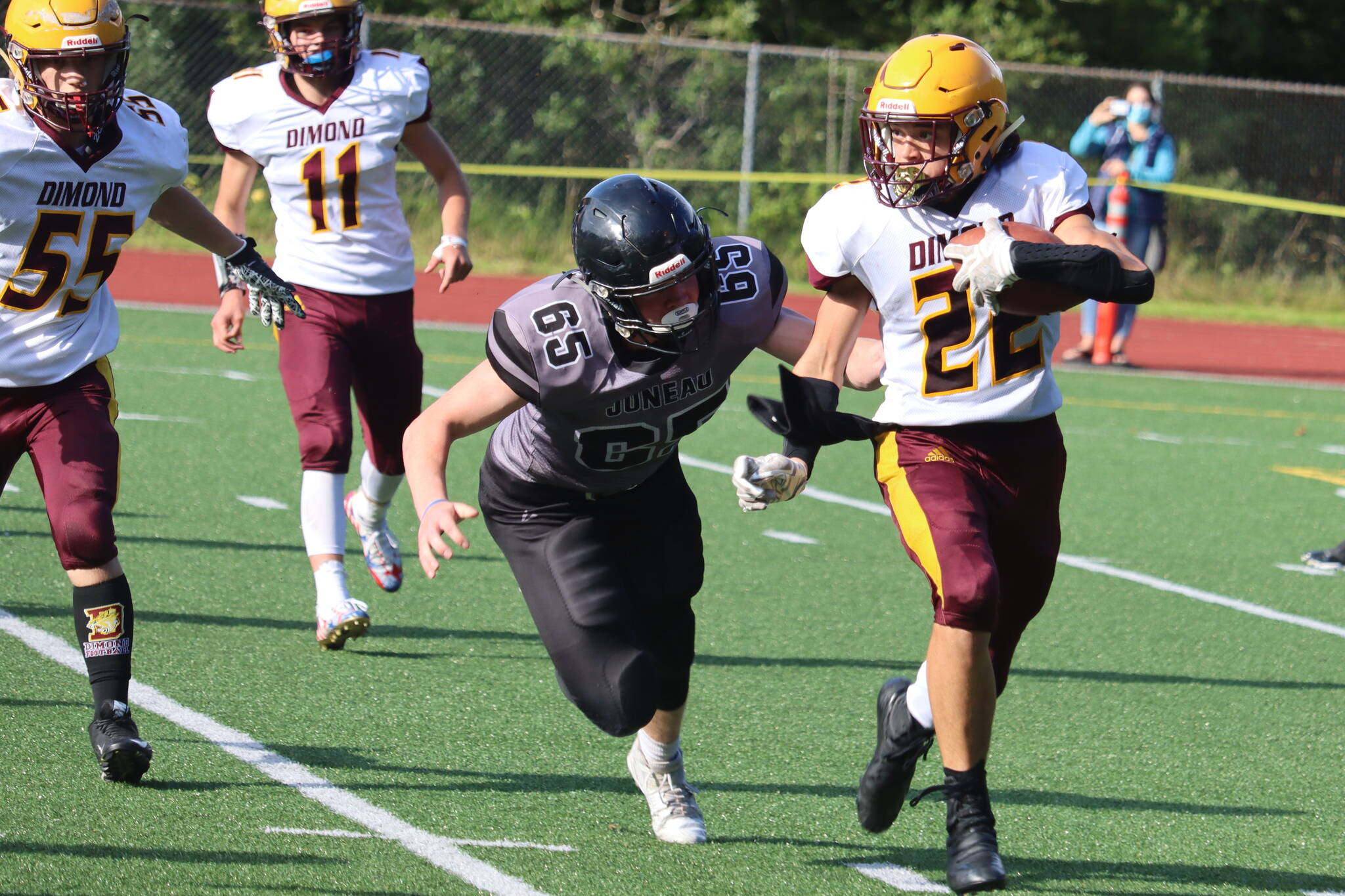 Brandon Campbell chases down a Dimond ball carrier during an Aug. 21 game. The Juneau Huskies and Dimond Lynx will face off again on Saturday. (Ben Hohenstatt / Juneau Empire File)