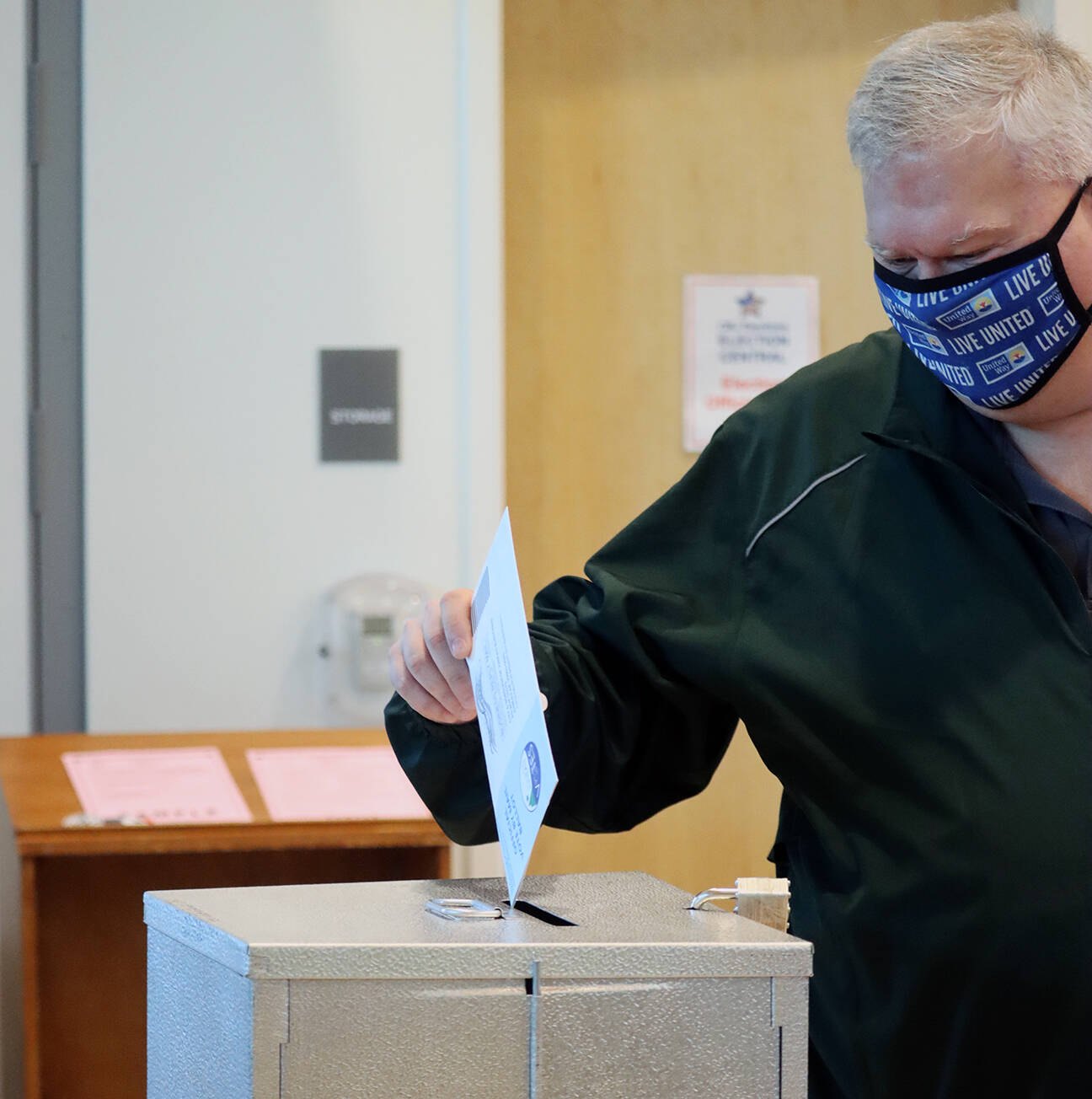 School board member Emil Mackey places a ballot in the drop box at the Mendenhall Public Library vote center on Tuesday.Two seats on the City and Borough of Juneau Assembly and three seats on the Juneau School District Board of Education are up for grabs in the 2021 municipal election. (Ben Hohenstatt / Juneau Empire)