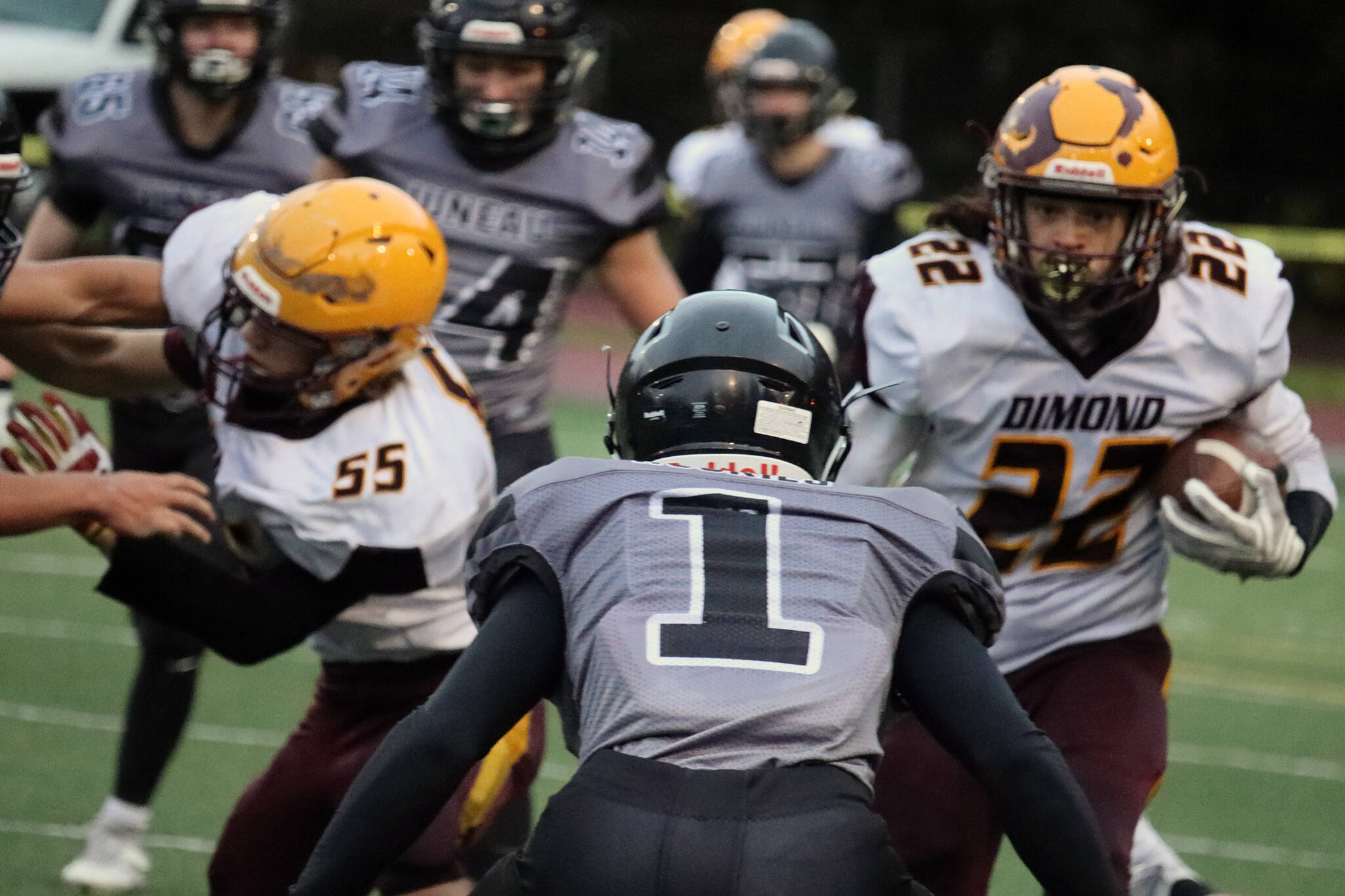Jarrell Williams, a junior defensive back, prepares to tackle Roman Smith. (Ben Hohenstatt / Juneau Empire)