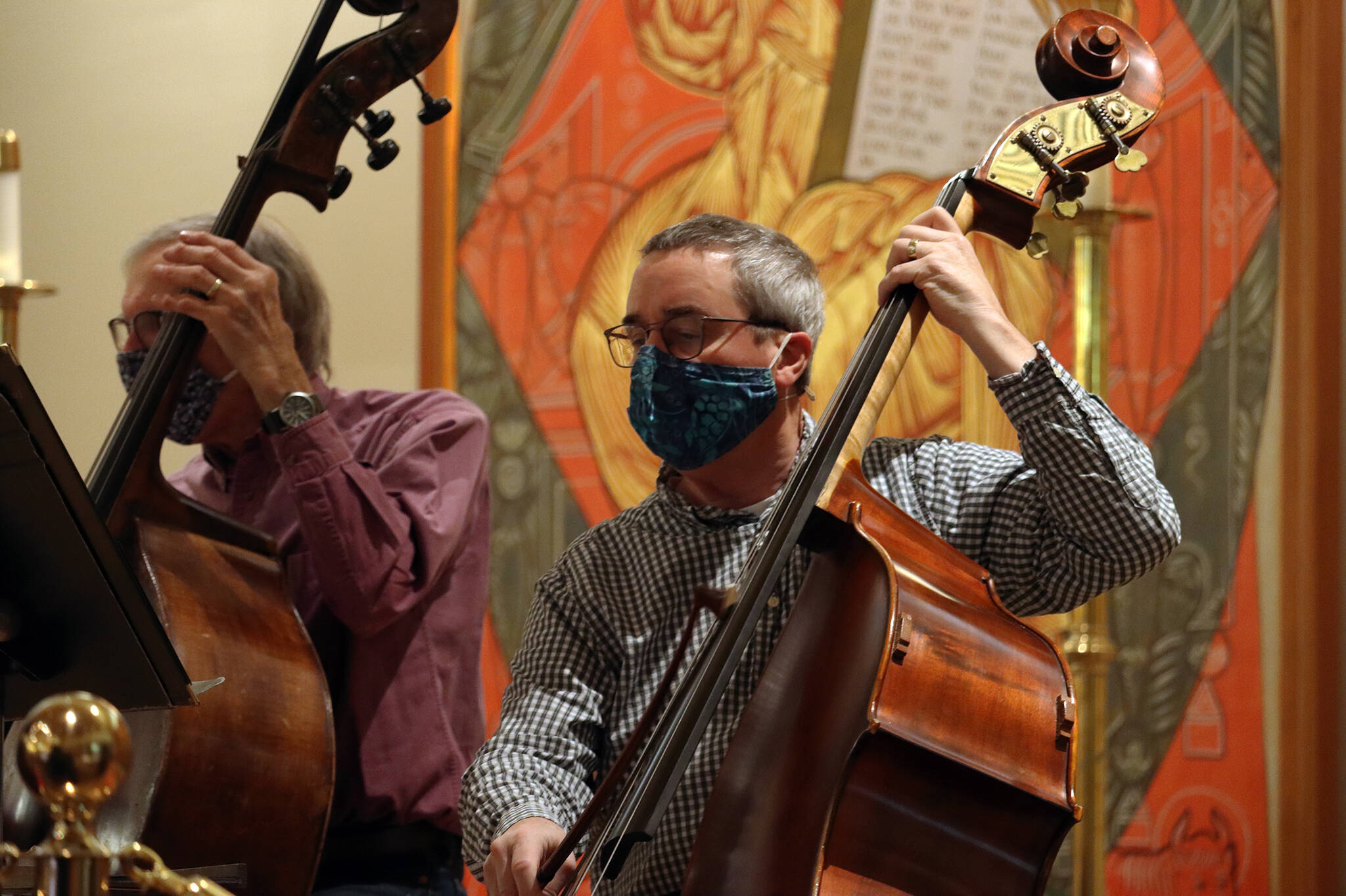 Playing bass in a mask was no “treble” for Wilson Valentine (right) and John Staub during rehearsals ahead of Juneau Symphony’s return to in-person performances. (Ben Hohenstatt / Juneau Empire)