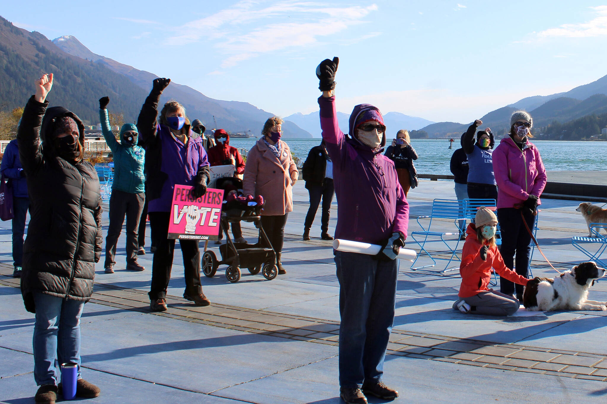 Ben Hohenstatt / Juneau Empire File 
Masked people raise their fists in the air during the 2020 Juneau women’s march and rally at Mayor Bill Overstreet Park.
