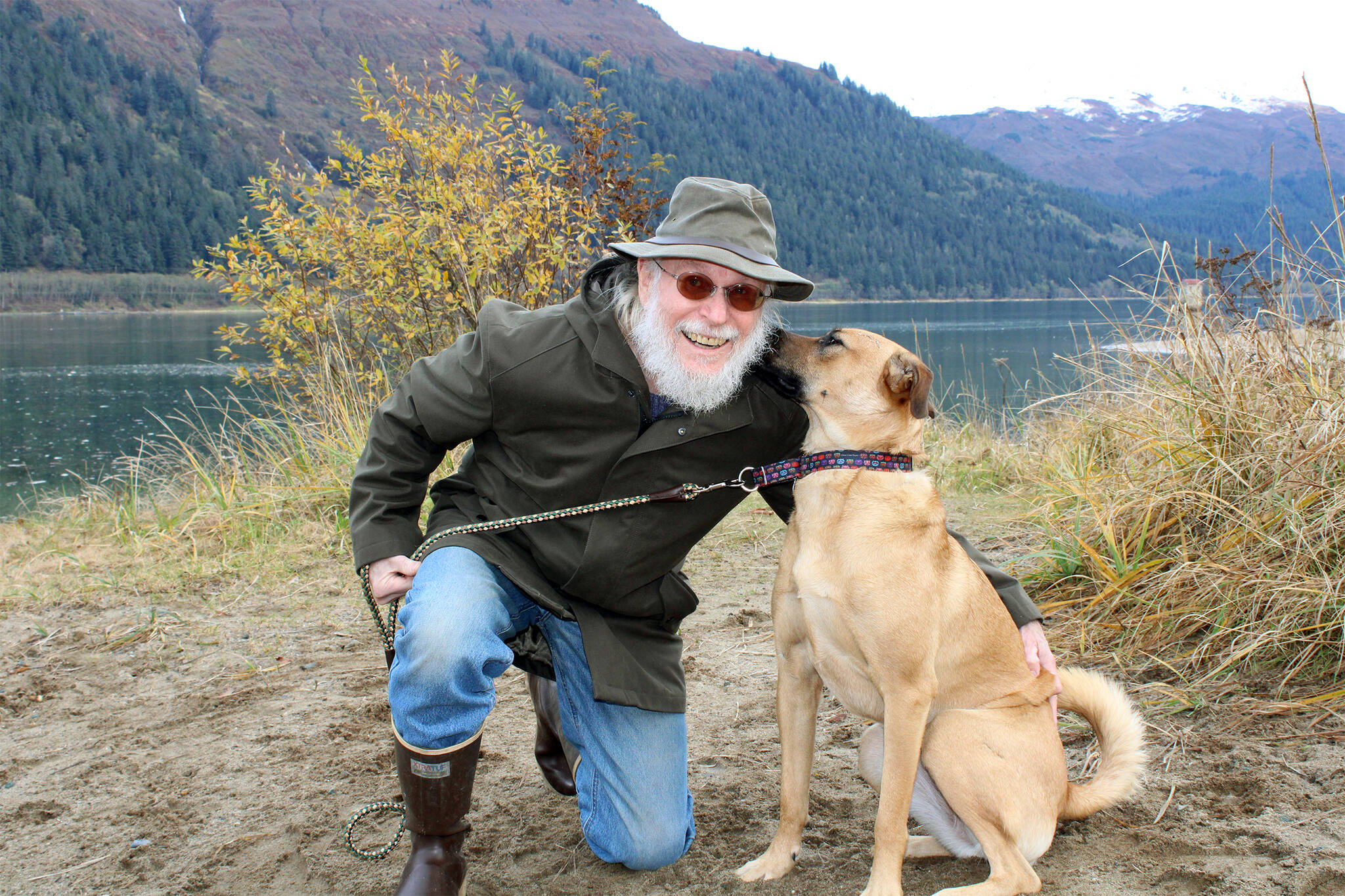 Carl Schrader and his dog, Luna, on Sandy Beach on Oct. 18. Schrader, who is a longtime hospice volunteer, credits a strong personal meditation practice and walks with his dog with helping him restore his emotional energy after working with people who are dying and their families. (Dana Zigmund/Juneau Empire)