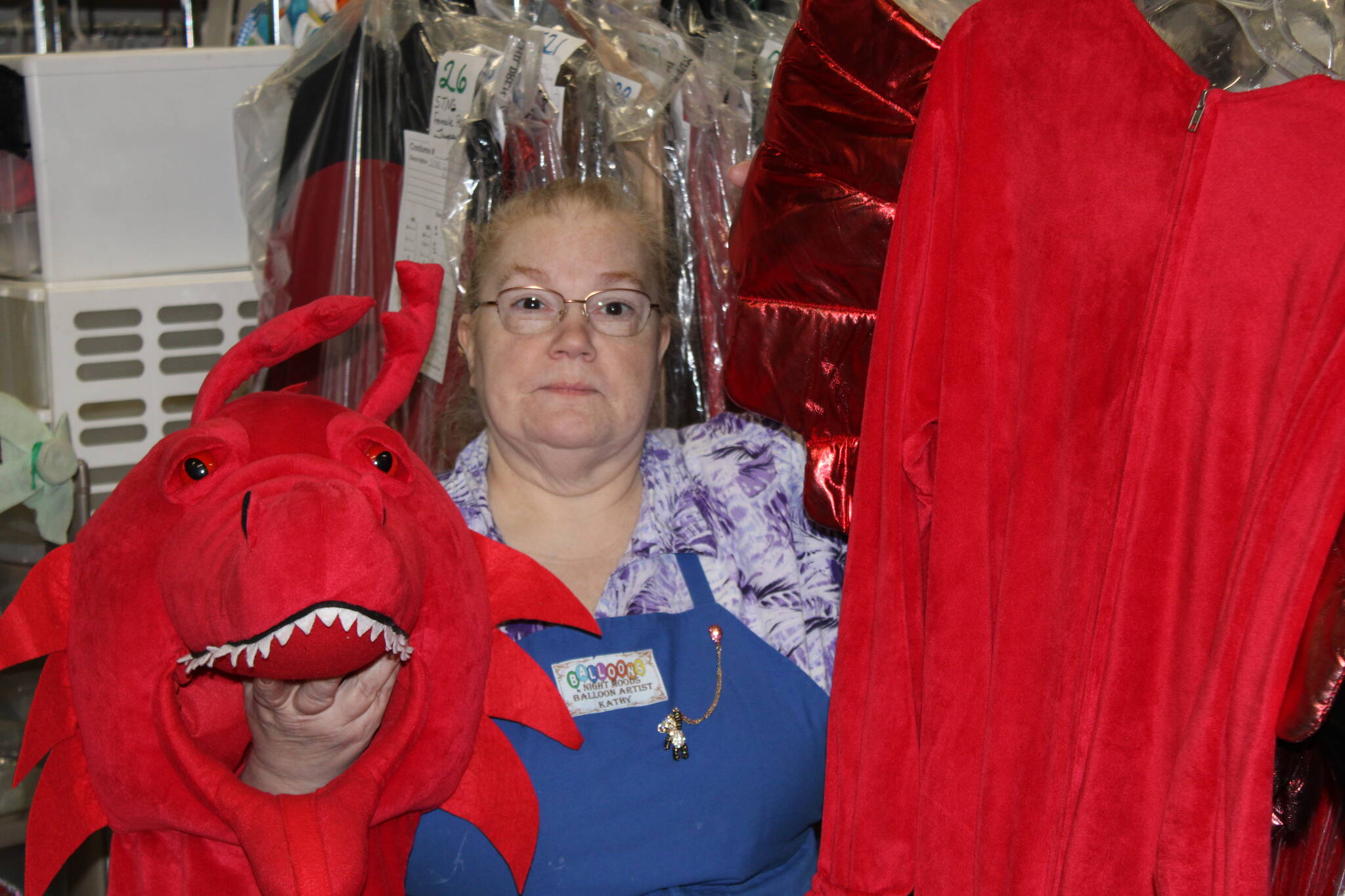 Self-described costume enthusiast and owner of Balloons by Night Moods, Kathy Buell, displays a dragon costume on Oct. 27. She said that the shop offers costumes for men, women and children and that plenty remain available for this weekend's festivities. (Dana Zigmund/Juneau Empire)