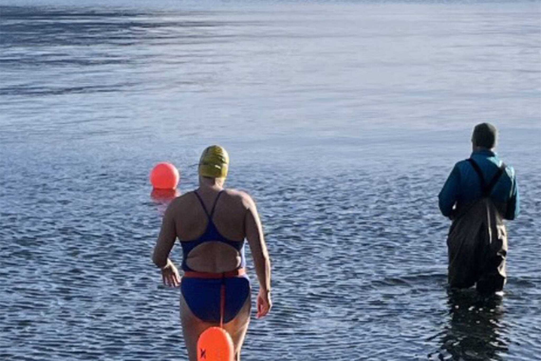 Cheryl Fellman enters the chilly waters of Auke Bay. Freeman is on the verge of becoming one of only 43 Americans — and 422 people worldwide — to swim an official Ice Mile. (Courtesy photo/Cheryl Fellman)