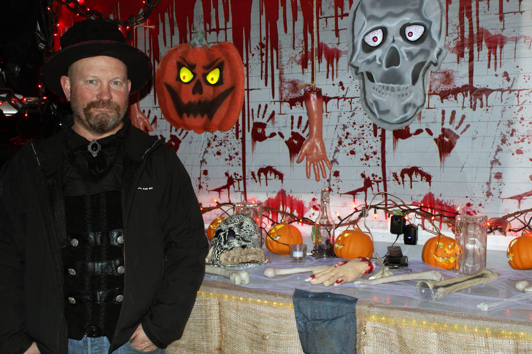 Dan Earls shows off some of the scenes on display at Earls Haunted Garage. On Oct. 28, he was adding finishing touches to his display in anticipation of thrill-seekers who will stop by for a scare over Halloween weekend. (Dana Zigmund/Juneau Empire)