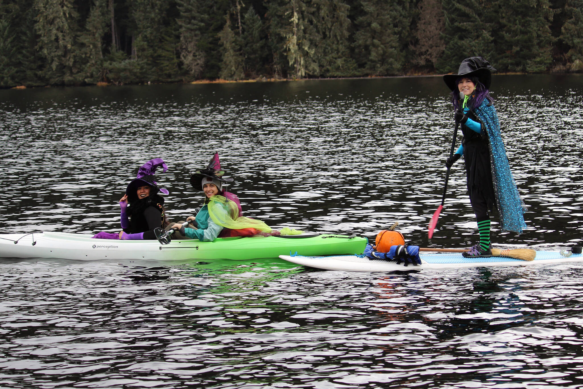 Marisol Elizarraras, left, Kira Shollenberger, center, and Bev O’Brien, right, take part in the first Witches Paddle on Auke Lake on Saturday, Oct. 30. (Dana Zigmund/Juneau Empire)