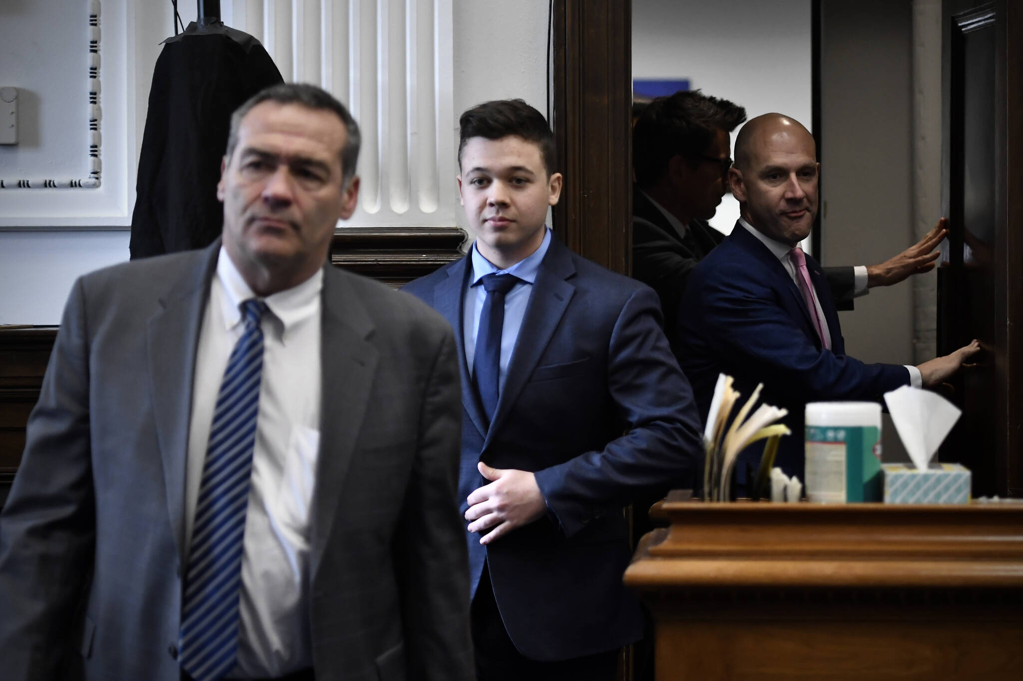 Kyle Rittenhouse, center, enters the courtroom with his attorneys Mark Richards, left, and Corey Chirafisi for a meeting called by Judge Bruce Schroeder at the Kenosha County Courthouse in Kenosha, Wis., on Thursday, Nov. 18, 2021. (Sean Krajacic / The Kenosha News)