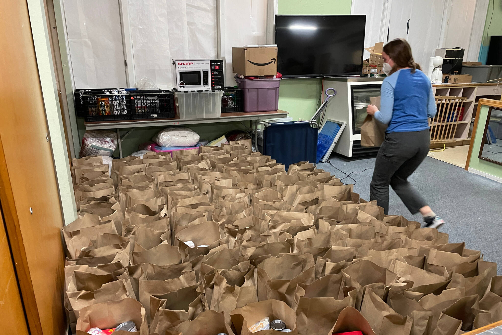 Michael S. Lockett / Juneau Empire
Grace Sikes from the Thunder Mountain High School Interact Club places readied food baskets in a row at the Juneau Society of St. Vincent de Paul on Nov. 18.
