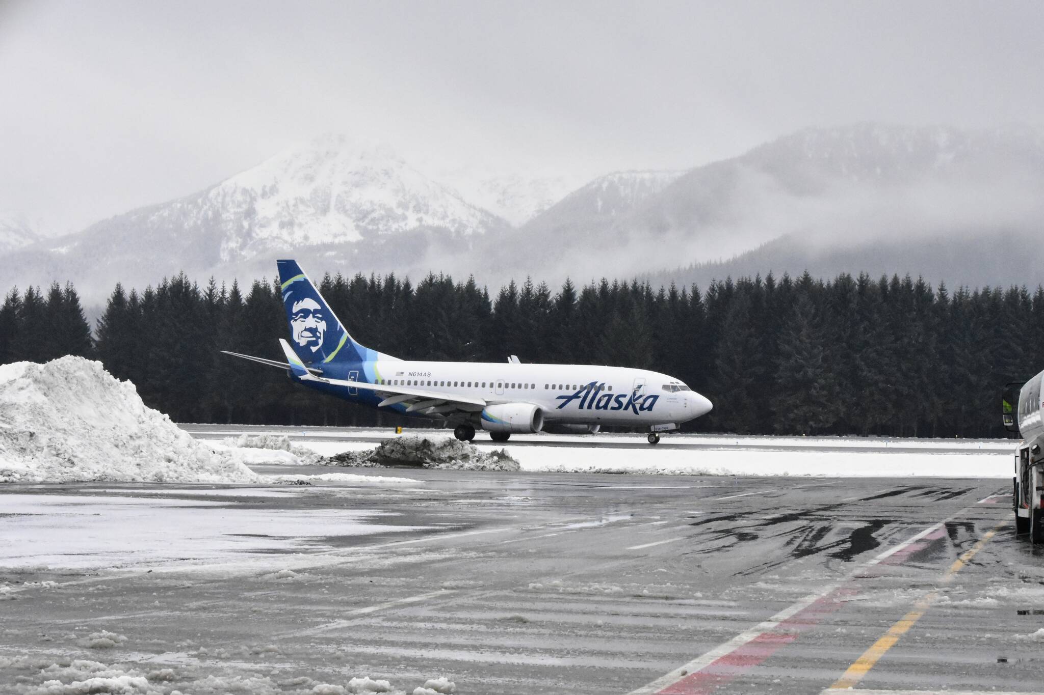 An Alaska Airlines flight lands at the Juneau International Airport on Monday, Nov. 22, 2021, amid a day of rain and snow. The National Weather Services issued a winter storm warning for Tuesday to Thursday, which covers “Black Wednesday,” the busiest travel day of the year. (Peter Segall / Juneau Empire)