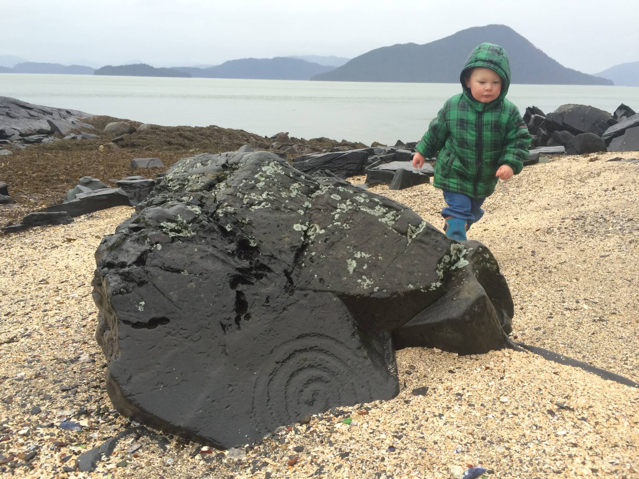 Vivian Faith Prescott / For the Capital City Weekly 
Grandson Jonah Hurst walks among the petroglyphs at Petroglyph Beach.