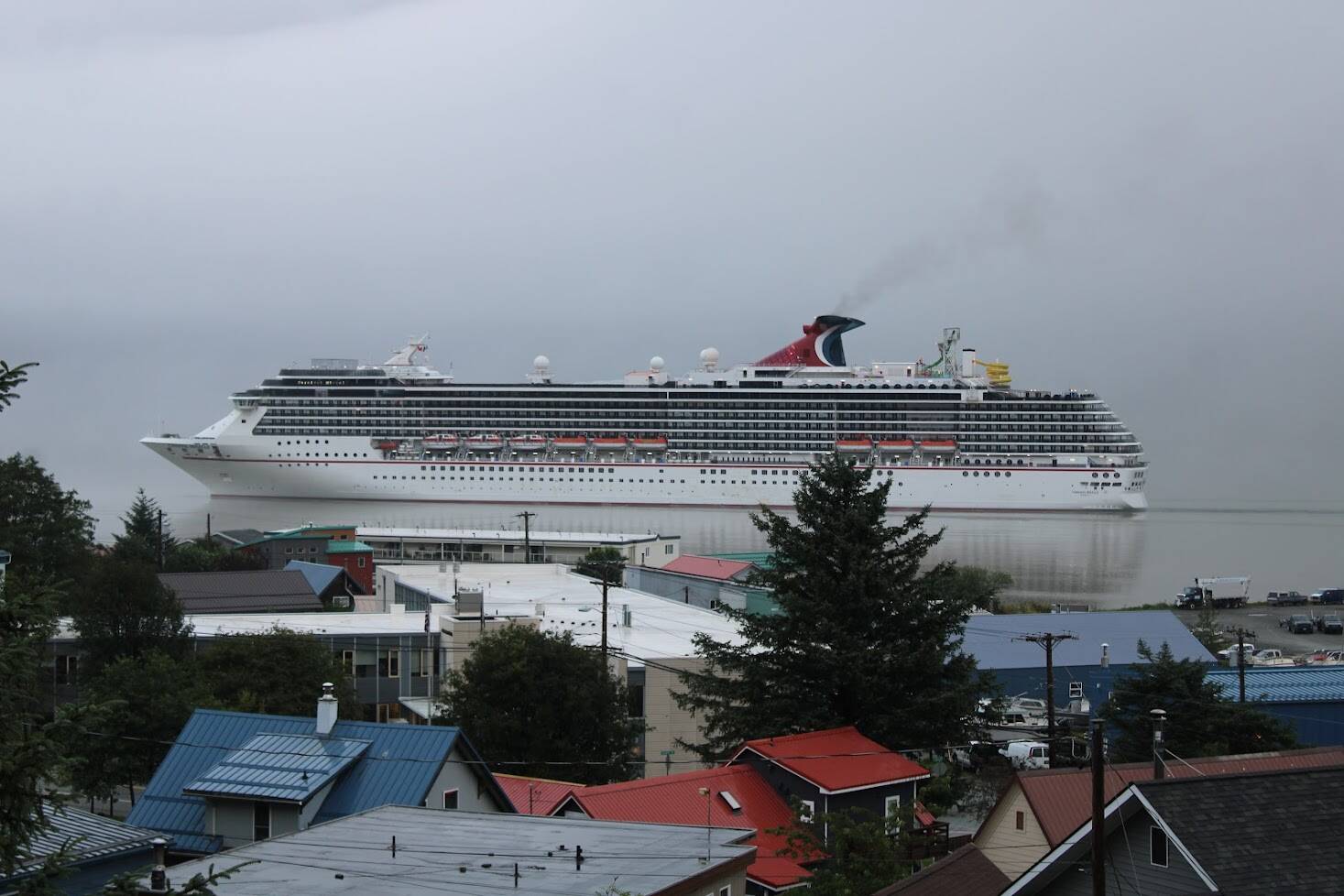 A Carnival cruise ship arrives in Juneau early in the morning on Aug. 14. Local business owners say that the short and significantly scaled back 2021 cruise season was welcome after the cancelation of the 2020 season. However, they say it was not enough and they are struggling to survive. (Dana Zigmund/Juneau Empire)