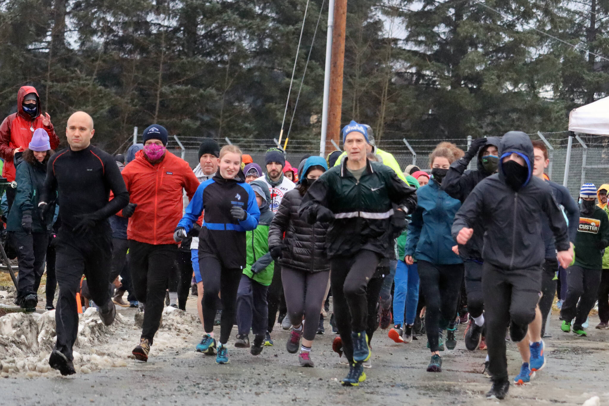 Ben Hohenstatt / Juneau Empire 
Participants in the eighth annual Turkey Trot 5K take off from the starting line on a dreary Thanksgiving.