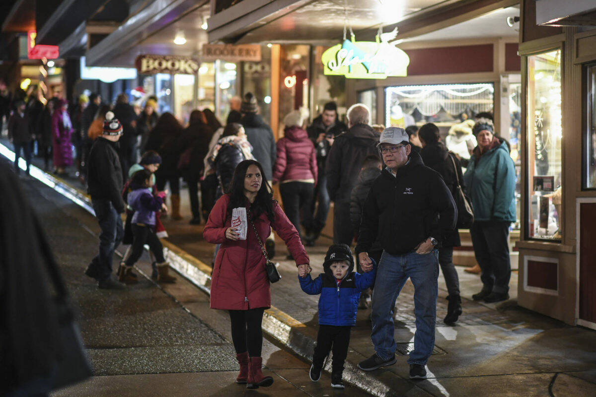 Residents walk Seward Street during Gallery Walk on Friday, Dec. 6, 2019. Gallery Walk returns in-person to downtown in 2021 with events and live music on Dec. 3, 2021. (Michael Penn / Juneau Empire file)