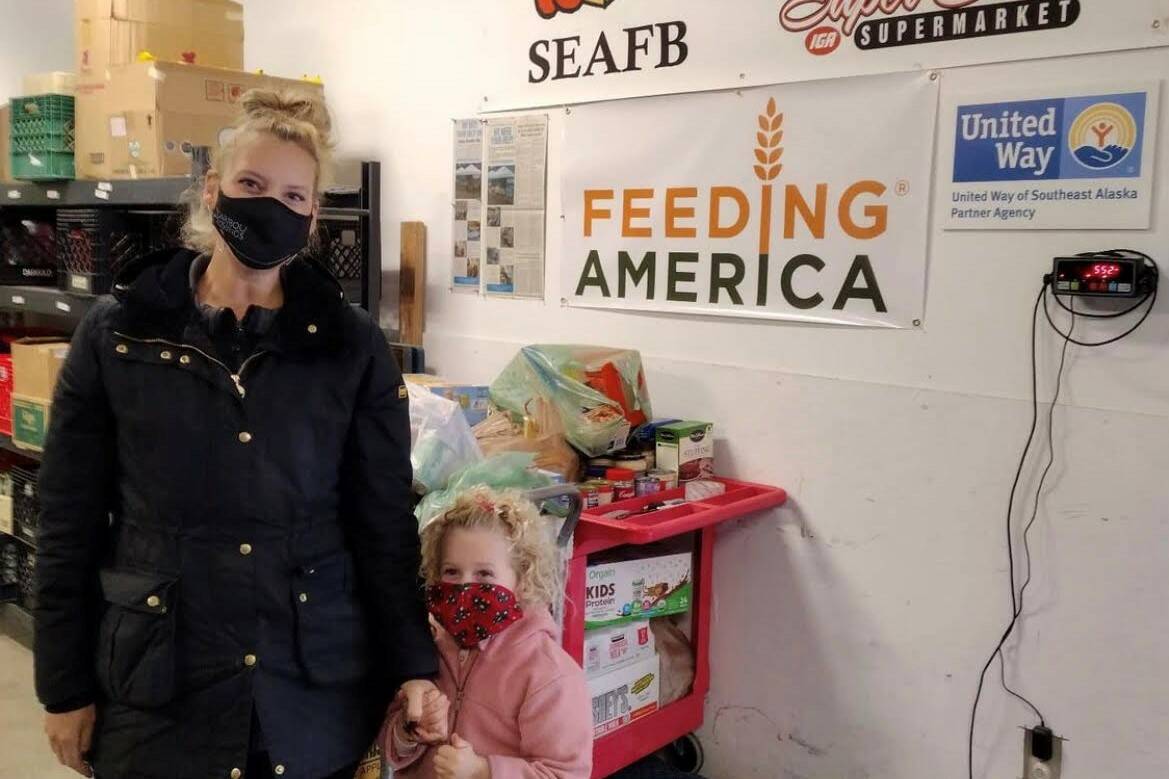 Courtesy photo/Laura Martinson 
Laura Martinson, owner of Caribou Crossings downtown and her 4-year old daughter, Olivia McDonnell, deliver food to the Southeast Alaska Food Bank.