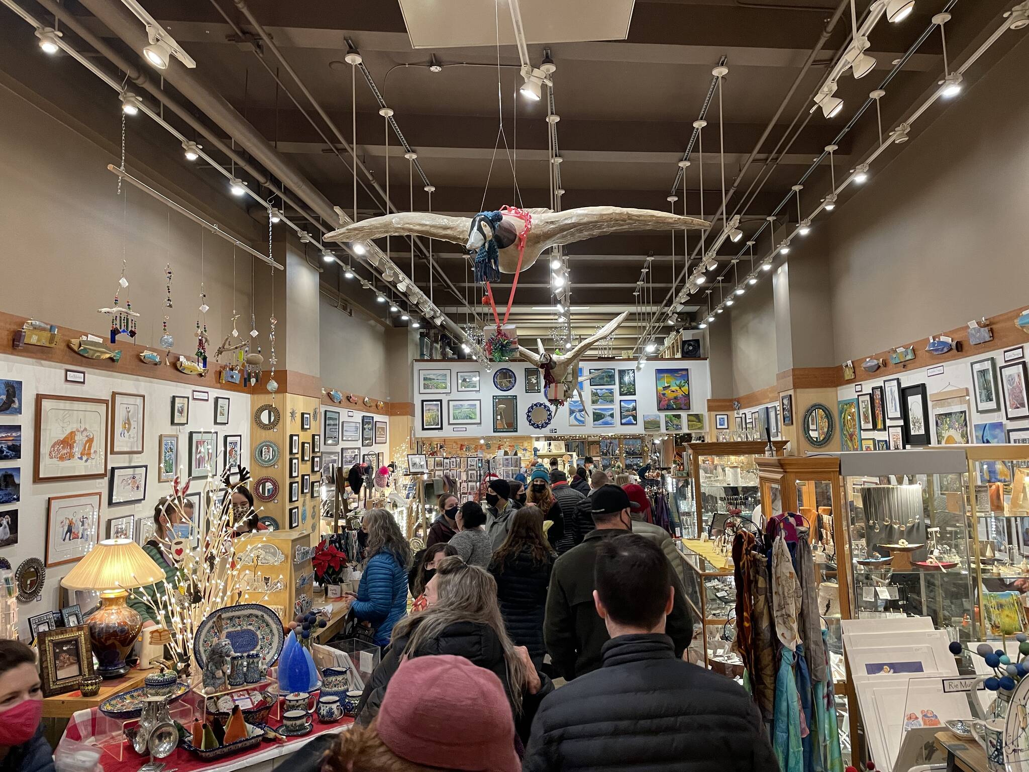 Shoppers peruse the selection at Annie Kaill’s during Gallery Walk on Dec. 3, 2021. (Michael S. Lockett / Juneau Empire)