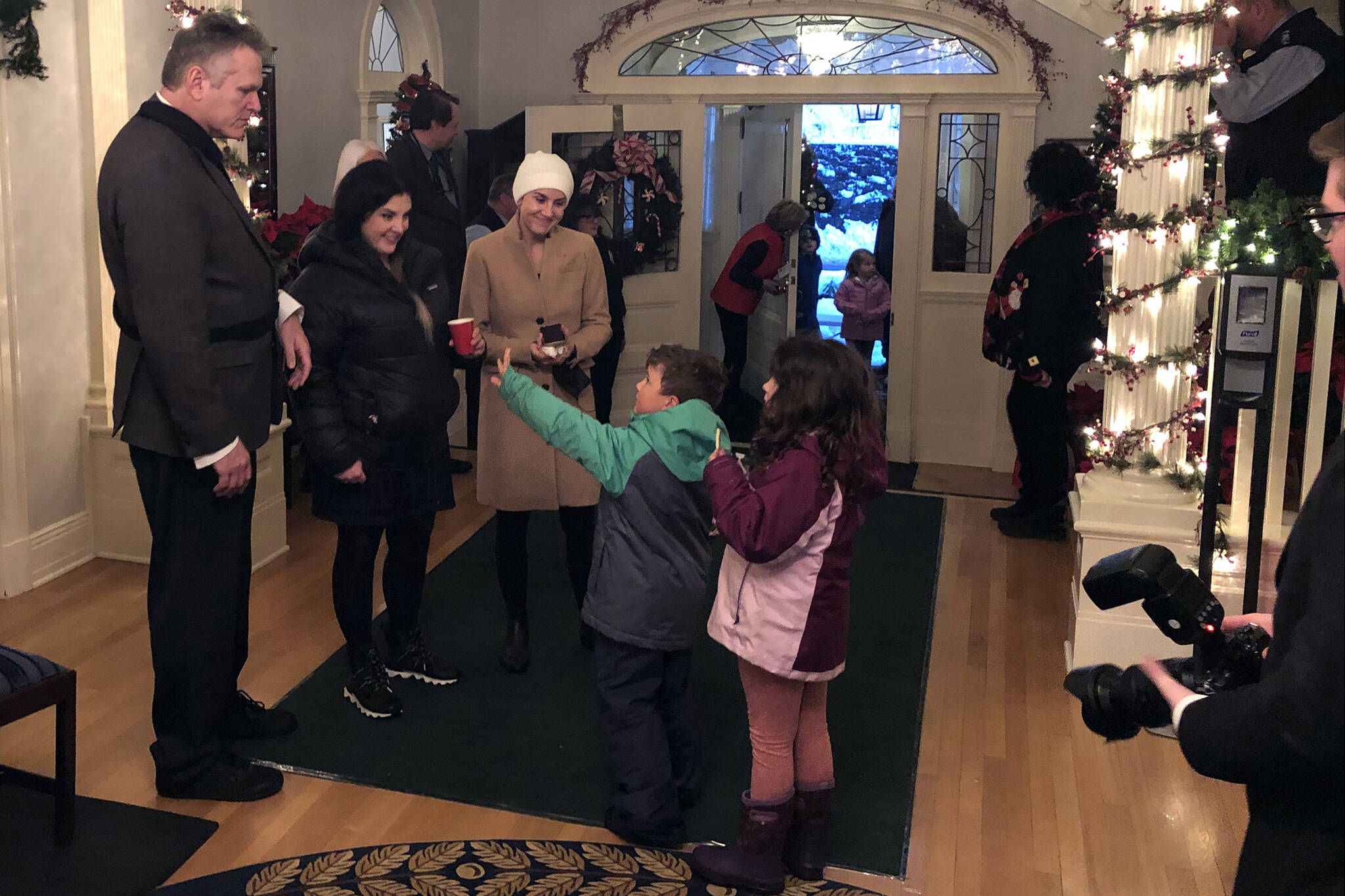 Children wave goodbye to Gov. Mike Dunleavy at a Christmas open house event at the Alaska Governor’s Mansion on Tuesday, Dec. 7, 2021. The event was suspended in 2020 due to COVID-19 but returned this year with slight health mitigation alterations. The event was well-attended by Juneau families. (Peter Segall / Juneau Empire)