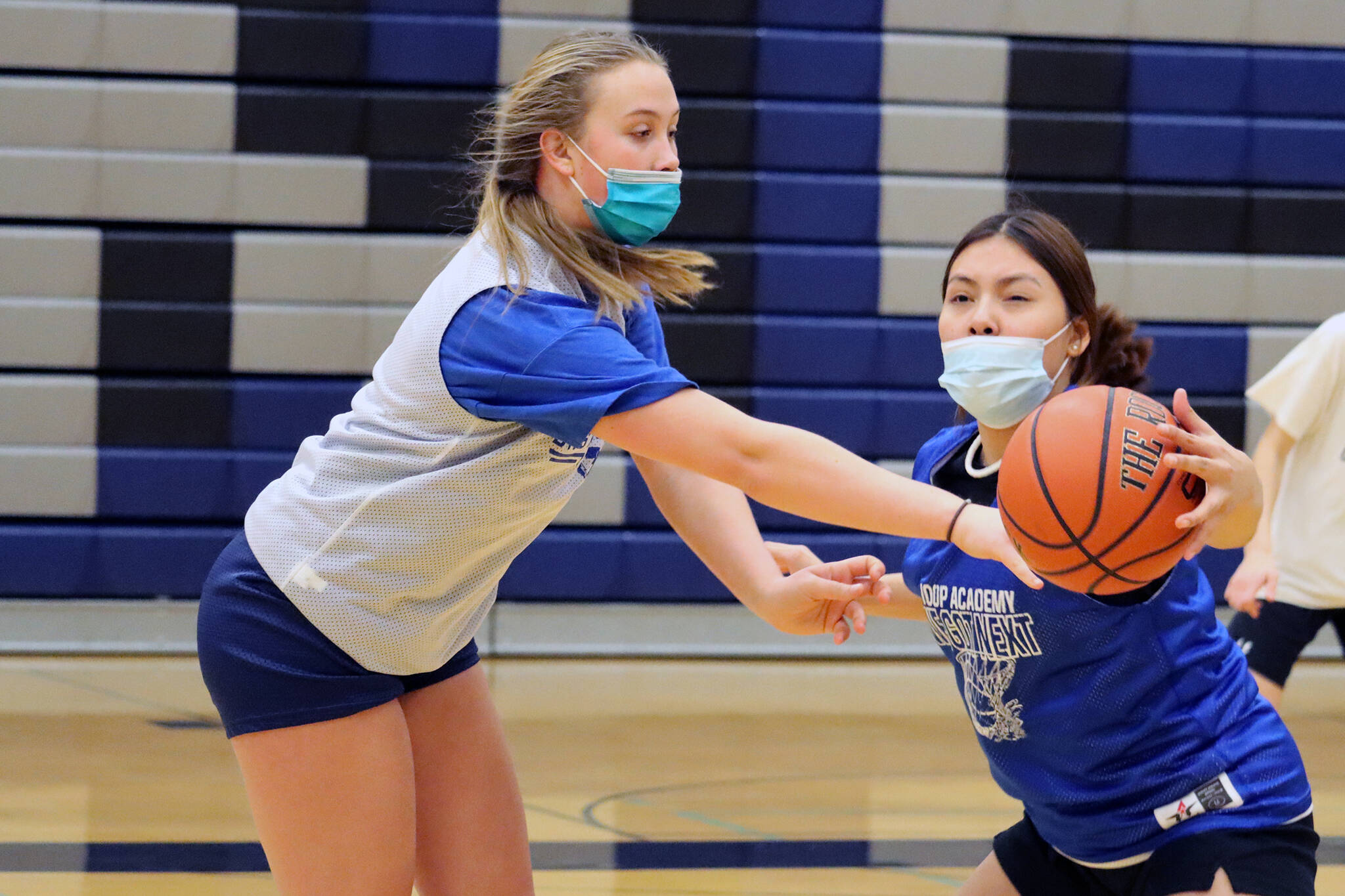 Kiara Kookesh (right) gets a hand on an attempted pass from Ashlyn Gates during a practice drill at Thunder Mountain High School. (Ben Hohenstatt / Juneau Empire)