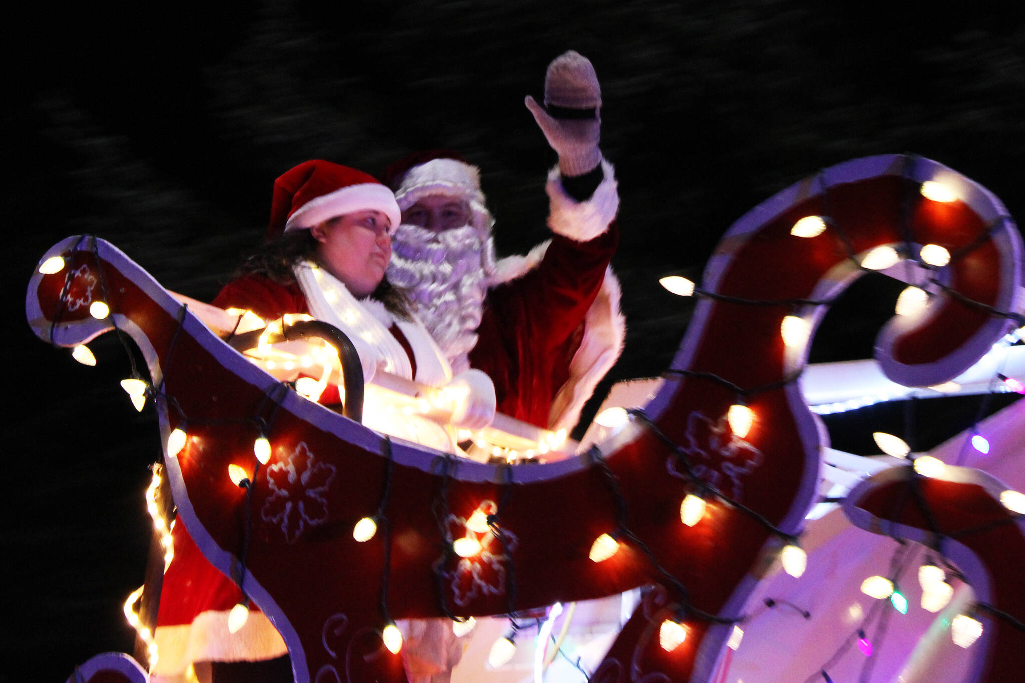 Santa Claus waves to Juneau residents who gathered—at a distance—to watch a holiday parade on Dec. 18, 2020. This year’s parades are scheduled for Friday and Saturday. ((Ben Hohenstatt / Juneau Empire File)