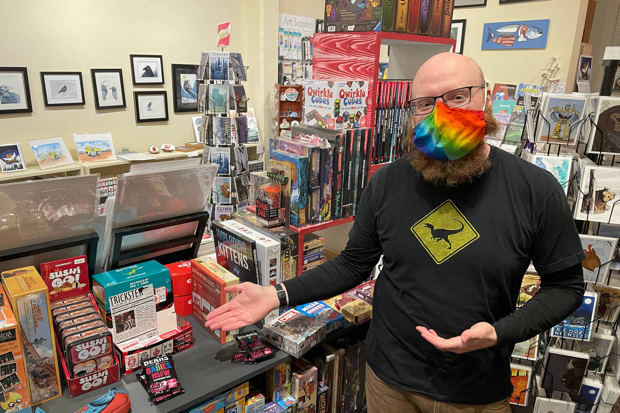 Alaska Robotics Gallery co-owner Aaron Suring gestures at Sushi Go!, one of a number of games locally obtainable and ideal for gifting this holiday season. (Michael S. Lockett / Juneau Empire)