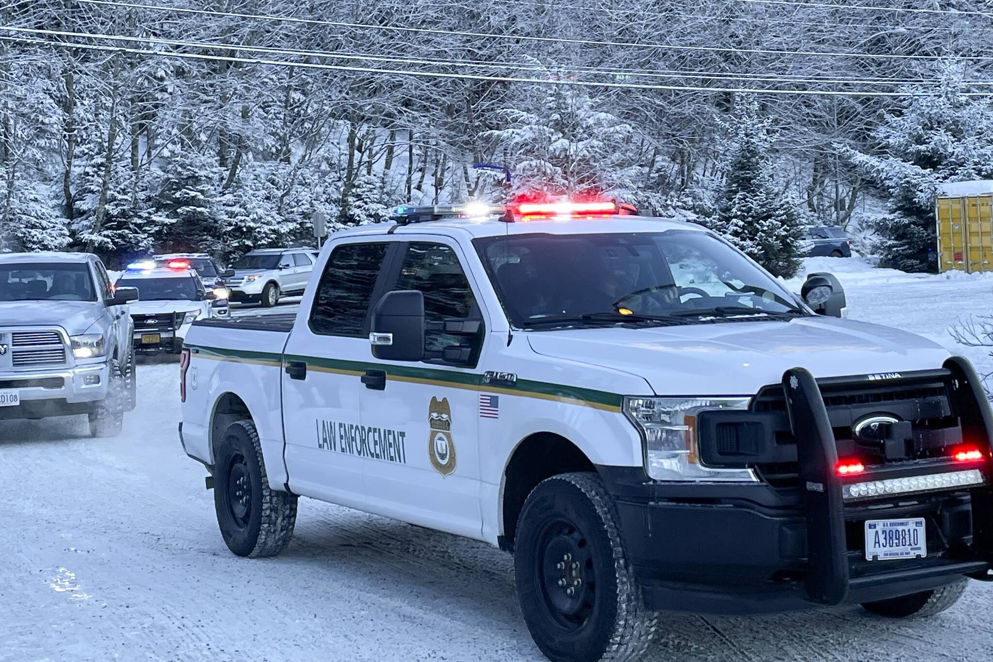 Vehicles convoy to Fred Meyer as Juneau law enforcement officials drive children to go shopping during the annual Shop with a Cop event on Dec. 18, 2021. (Michael S. Lockett / Juneau Empire)