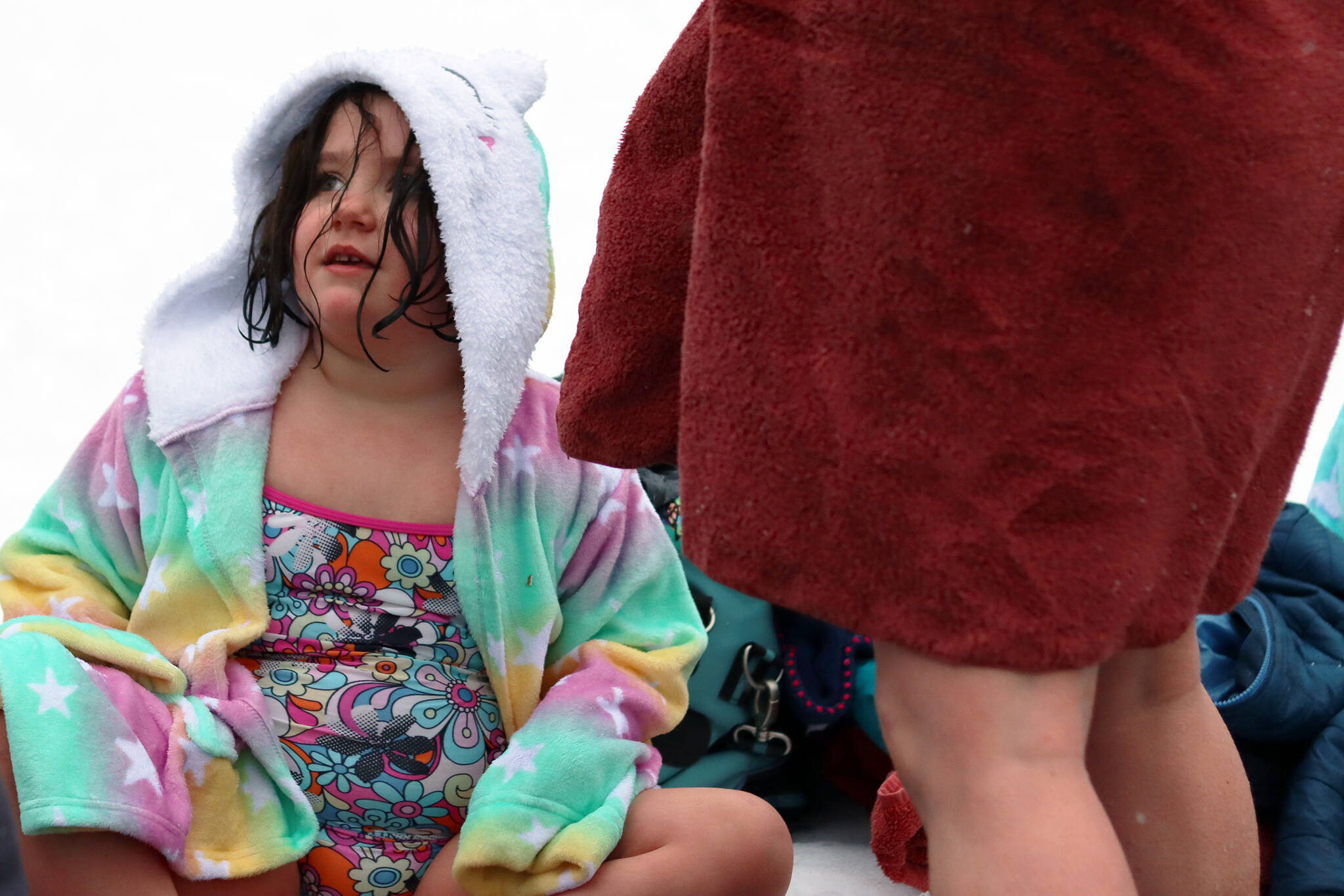 Juniper Harris, 6, dries off following the Polar Dip on Saturday. It was Harris’ first time taking the dip. The event is a long-running Juneau tradition. “She really wanted to after last year,” said Stephenie Harris, Juniper’s mom. She said Juniper skipped skiing to be there. (Ben Hohenstatt / Juneau Empire)