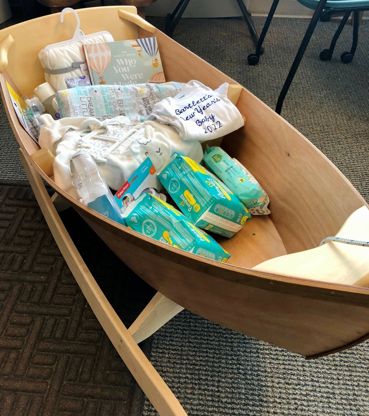 This photo shows a wooden boat built by Dr. Lindy Jones filled with a basket of goodies for the first baby born in Bartlett Regional Hospital in 2022. (Courtesy Photo / Lauren Beason, Bartlett Regional Hospital)