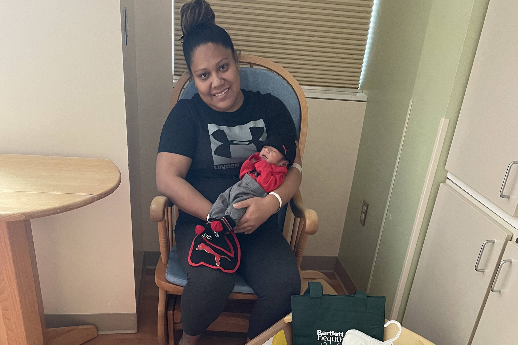 Faalo Nauer holds Greyson Tafia Nauer on Monday. Greyson, who was born on Sunday, was the first baby of 2022 born in Bartlett Regional Hospital. (Courtesy Photo / Kanani Montalto, Bartlett Regional Hospital)