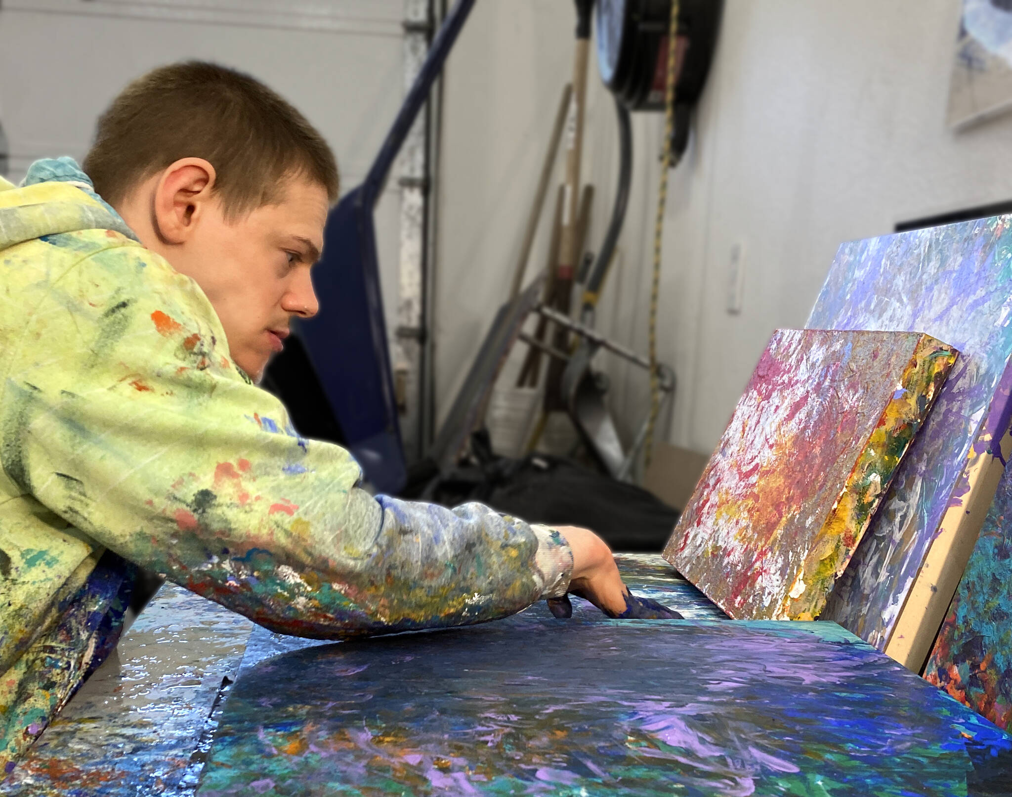 Avery Skaggs works on a painting. Skaggs’ work will be featured in an exhibit at the Juneau-Douglas City Museum that is opening on First Friday. (Courtesy Photo)