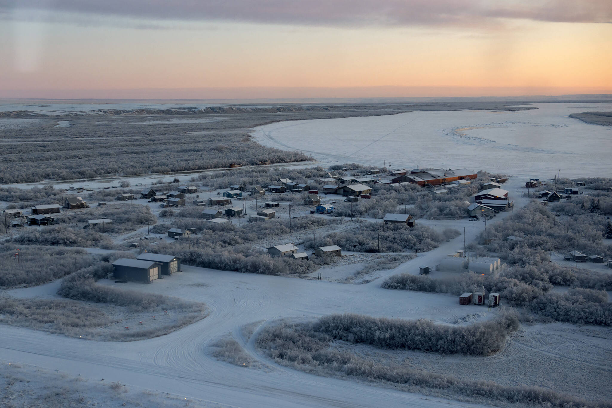 This photo provided by the U.S. Air Force/Alaska National Guard photo shows the William Miller Memorial School, larger structure top right, which is being severely eroded by the nearby Kuskokwim River in the village of Napakiak, Alaska, on Dec. 3, 2019. The school is just 64 feet (19.51 meters) from the Kuskokwim River, and it’s getting closer every year. Just two years ago, the school was less than 200 feet (60.96 meters) from the river. Climate change is a contributing factor in the erosion caused by the Kuskokwim, a river that becomes an ice highway for travelers in the winter. (Airman 1st Class Emily Farnsworth, U.S. Air Force/ Alaska National Guard)