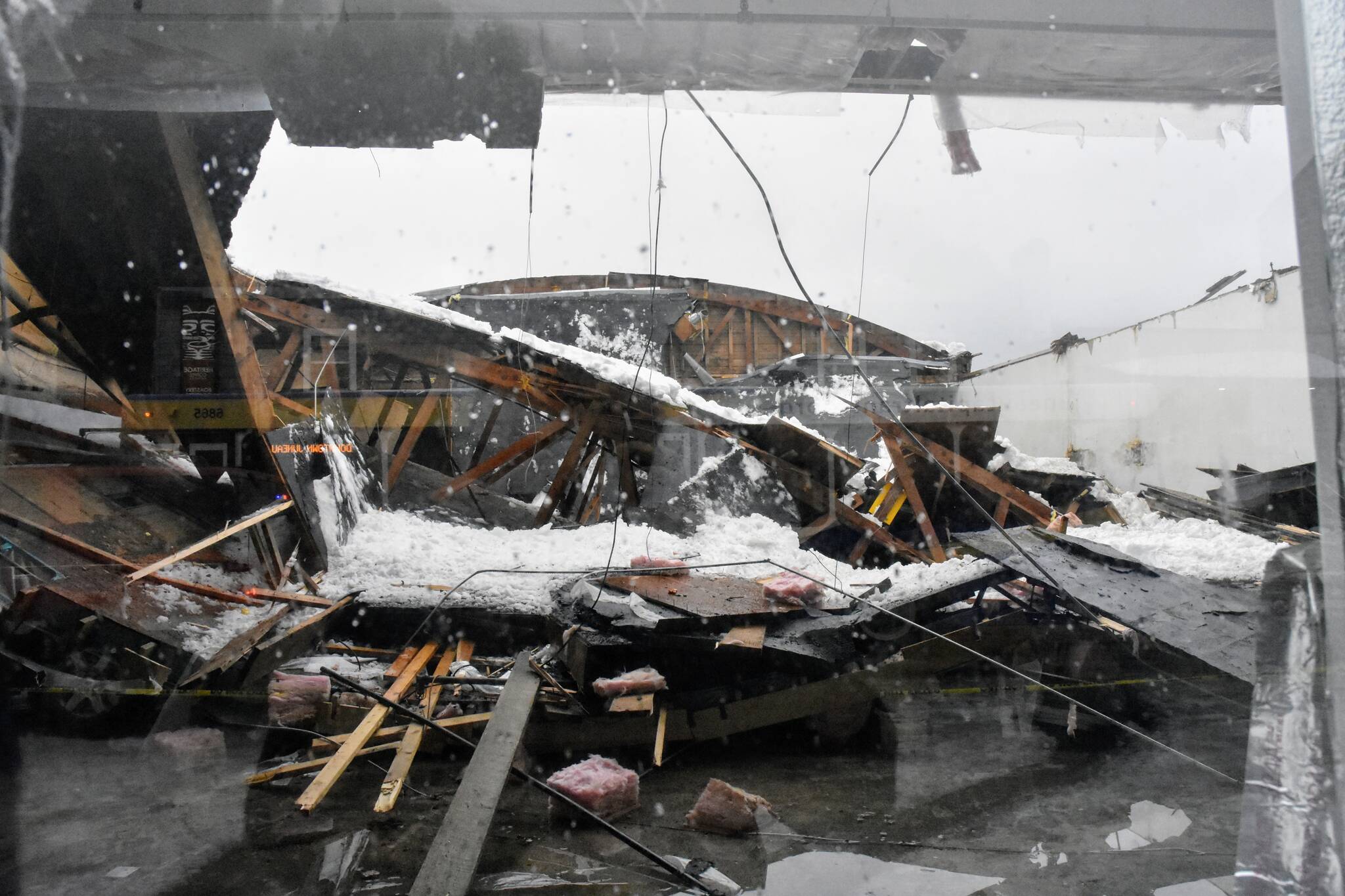 The roof of a building on Willoughby Avenue in downtown Juneau collapsed Tuesday, Jan. 11, 2022, one of two buildings in the city to fall in amid continuing rain following heavy snowfall. No injuries were reported at either location. (Peter Segall / Juneau Empire)