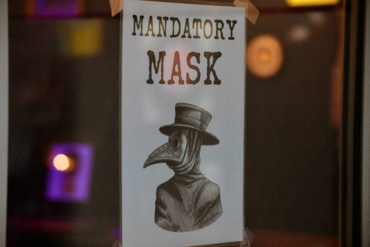 A sign seen on a downtown Juneau business reminds customers that masks are required. On Monday night, CBJ officials voted to extend the city’s COVID-related ordinances through April 30. (Peter Segall / Juneau Empire File)