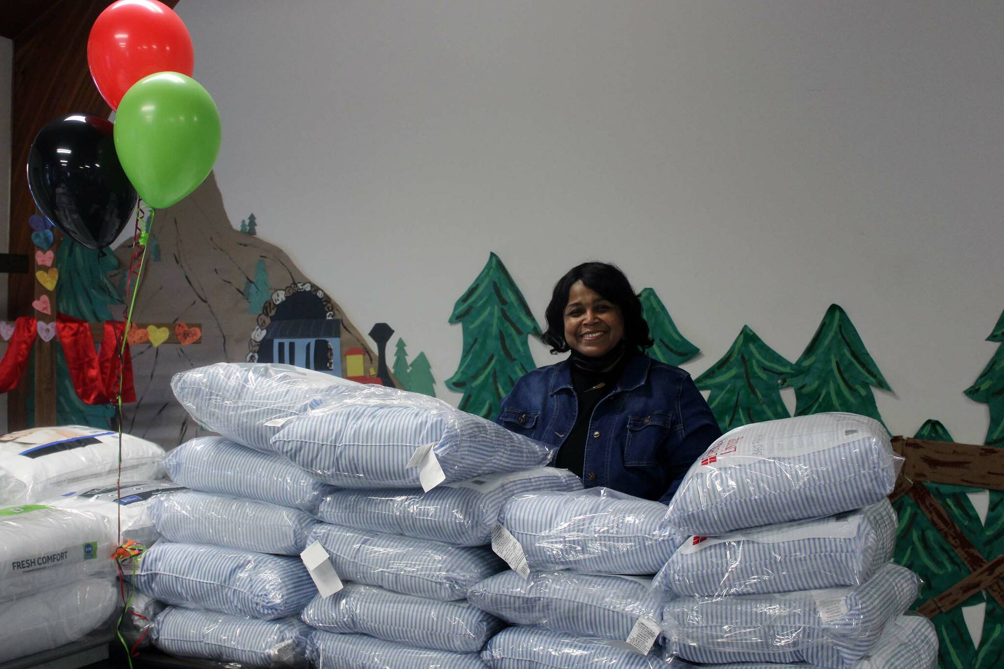 Sherry Patterson, president of the Black Awareness Association of Juneau, stands amid a mountain of donated pillows on Jan. 17. Patterson was part of a drive to collect food and household goods in honor of Martin Luther King Jr. Day. (Dana Zigmund/Juneau Empire)