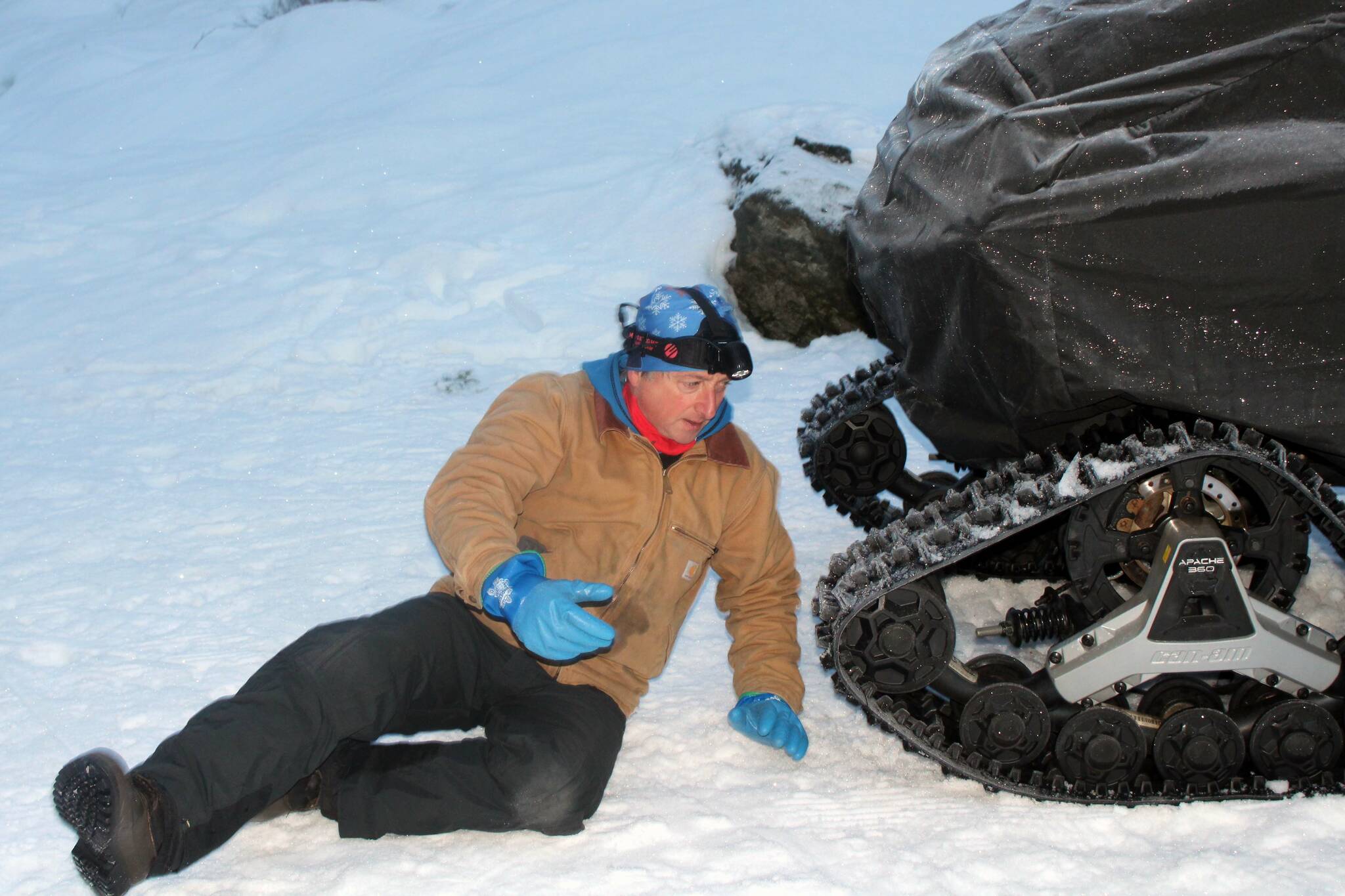 Wayne Carnes prepares the snow machine he will use to groom the Pioneer Road trail on North Douglas around 8:30 a.m. on Jan. 18. (Dana Zigmund/Juneau Empire)