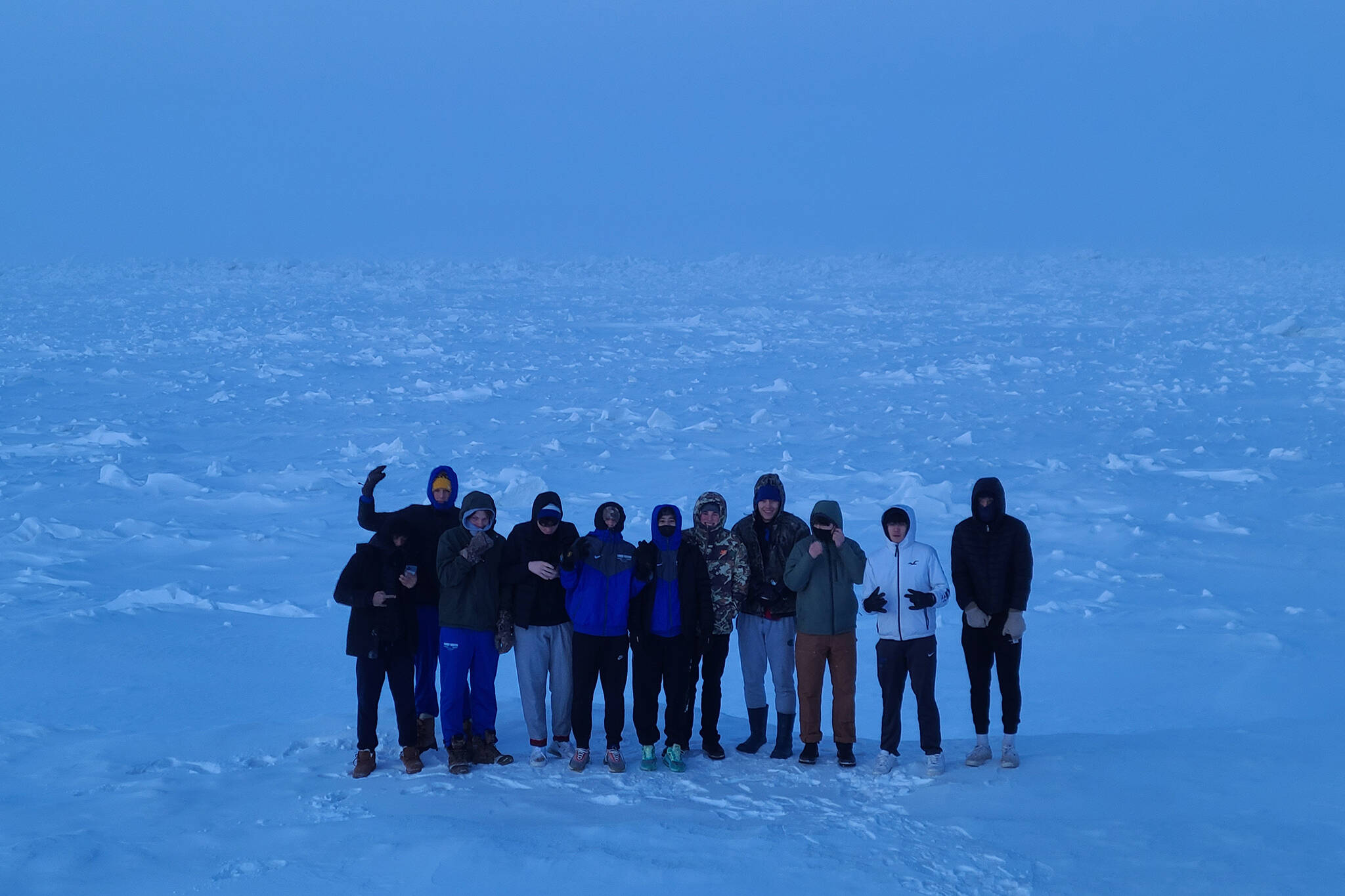 The Thunder Mountain High School boys basketball team stand on the Arctic Ocean. (Courtesy Photo)