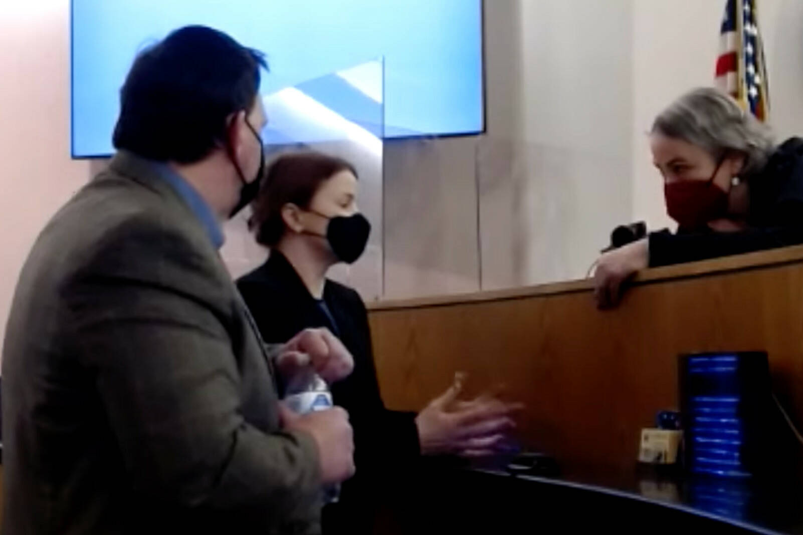 Public defender Eric Hedland, left, and District Attorney Angie Kemp consult with Superior Court Judge Amy Mead on Jan. 24, 2022 during a trial of a man accused of killing another man in Yakutat in 2018. (Screenshot)