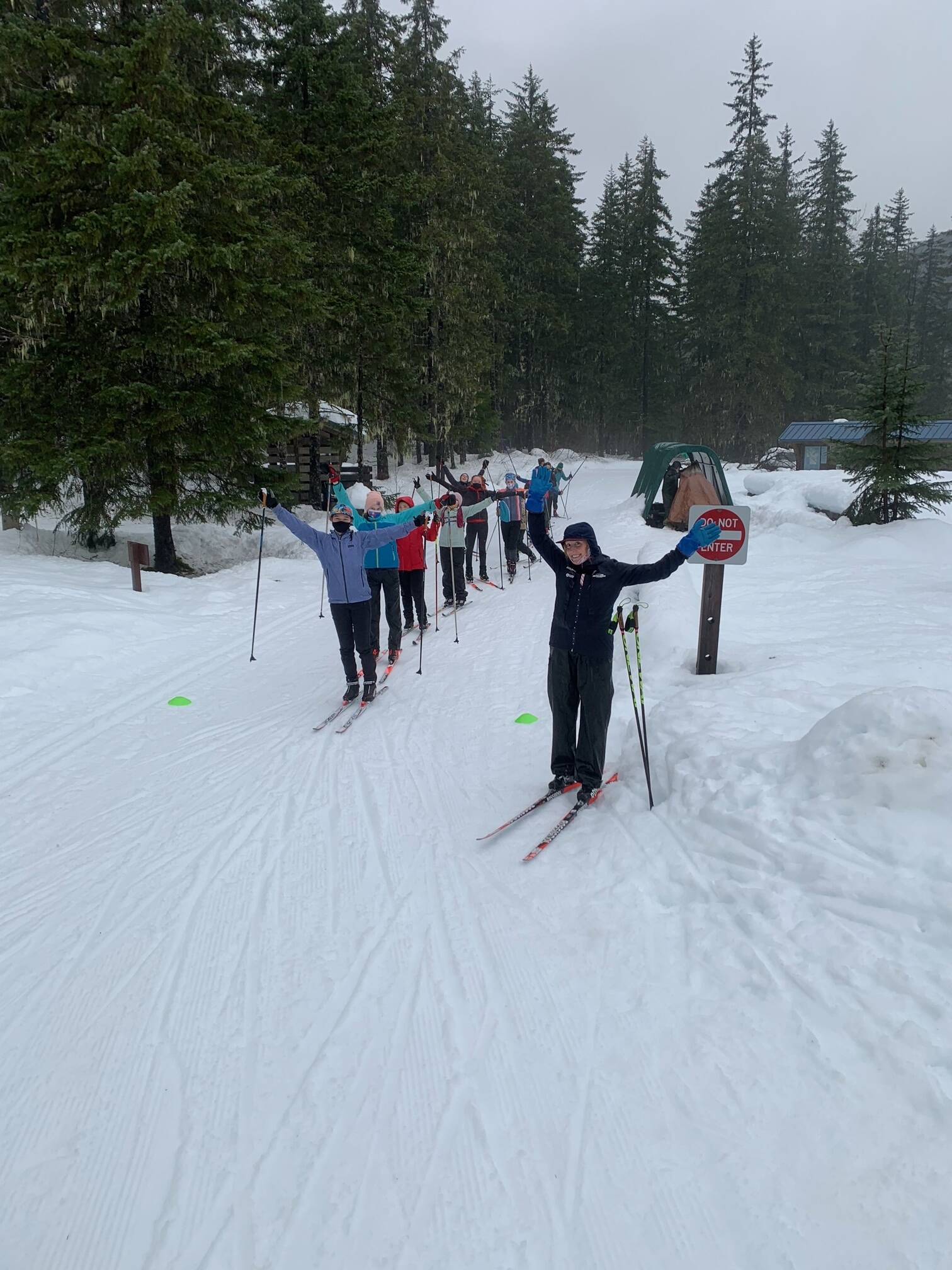 Courtesy Photo / Tristan Knutson-Lombardo 
Maddie Phaneuf, a Team USA biathlete, stands at the front of a line of skiers with her arms outstretched. Phaneuf was recently in town as a guest coach for Juneau Nordic Ski teams. Coaches said it’s excited to bring in professionals with outside perspective.