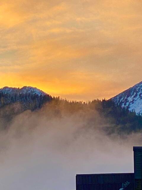 Fog rises in an attempt to obscure the golden glow above the Douglas range on Jan. 31. (Courtesy Photo / Denise Carroll)