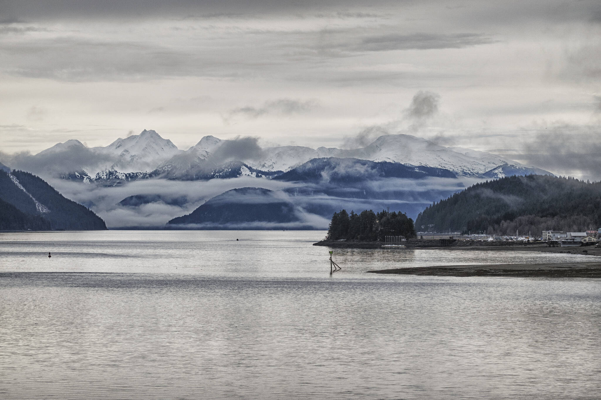 This photo shows the view down Gastineau Channel from the Douglas Bridge with clouds hanging over Williams, Butler and Irving peaks at Taku Inlet. (Courtesy Photo / Kenneth Gill, gillfoto)