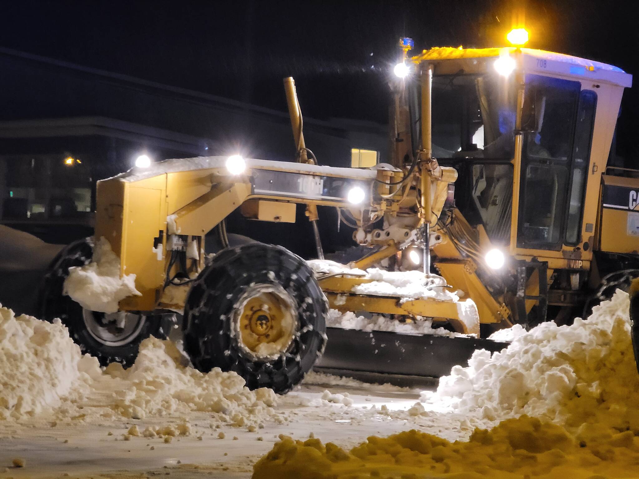 Ben Hohenstatt / Juneau Empire
A city-owned grader moves snow before dawn on Feb. 4 on Tongass Boulevard in the Mendenhall Valley. City snow removal crews have been challenged by multiple winter storms and higher-than-average snowfall.