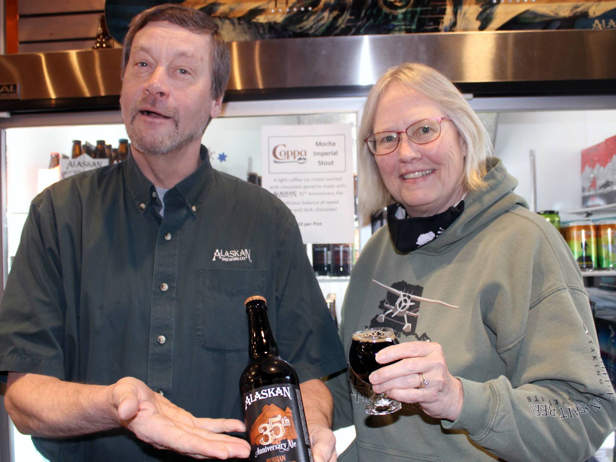 Geoff and Marcy Larson show off a special beer being brewed to celebrate the brewery’s 35th anniversary on Feb. 4. (Dana Zigmund / Juneau Empire)