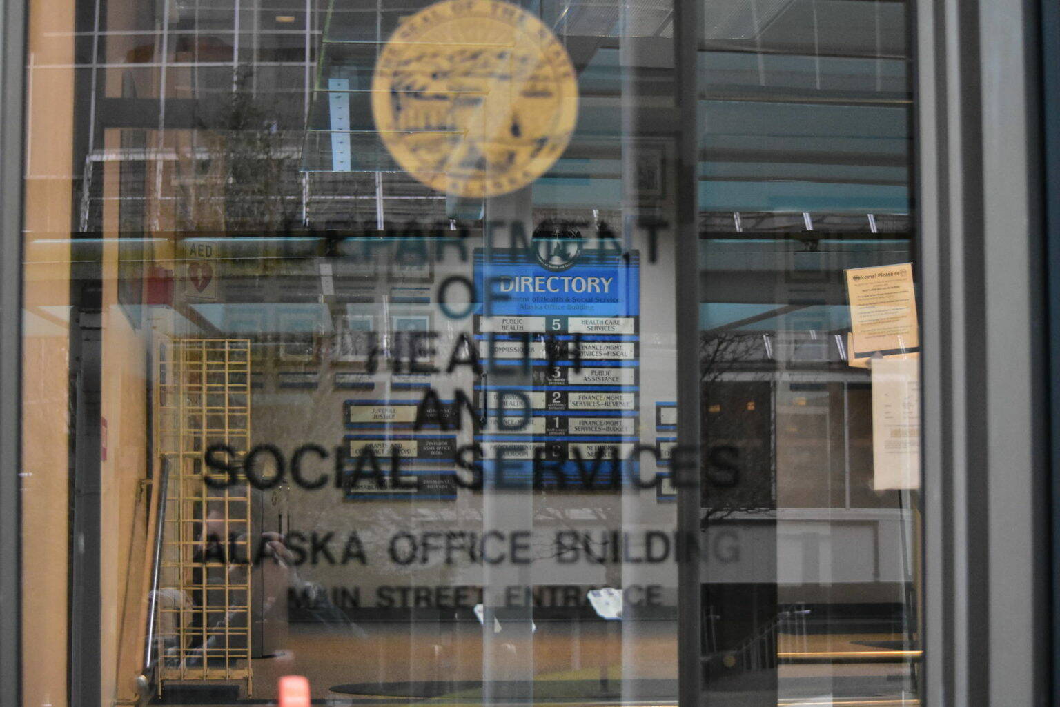 The entrance to the Alaska Department of Health and Social Services building in downtown Juneau on Jan. 14, 2021. Gov. Mike Dunleavy has twice proposed splitting the department using an executive order, but the Division of Legislative Legal Services has raised issues with the most recent order. (Peter Segall / Juneau Empire file)