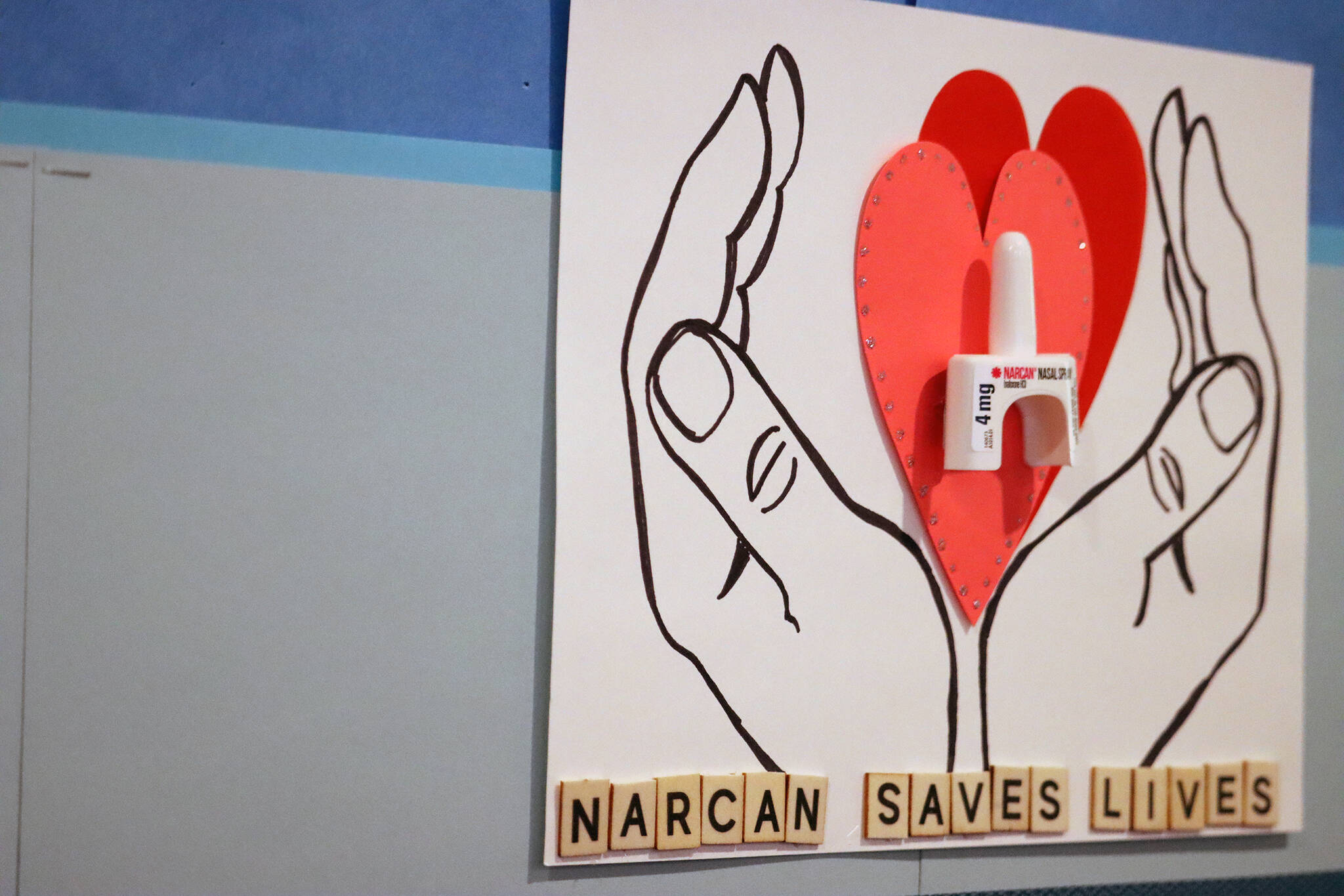 A poster at Juneau Public Health Center touts the benefits of Narcan. Capital City Fire/Rescue has received 100 kits containing the potentially life-saving drug to distribute to community members who need them beginning in March. (Ben Hohenstatt / Juneau Empire File)