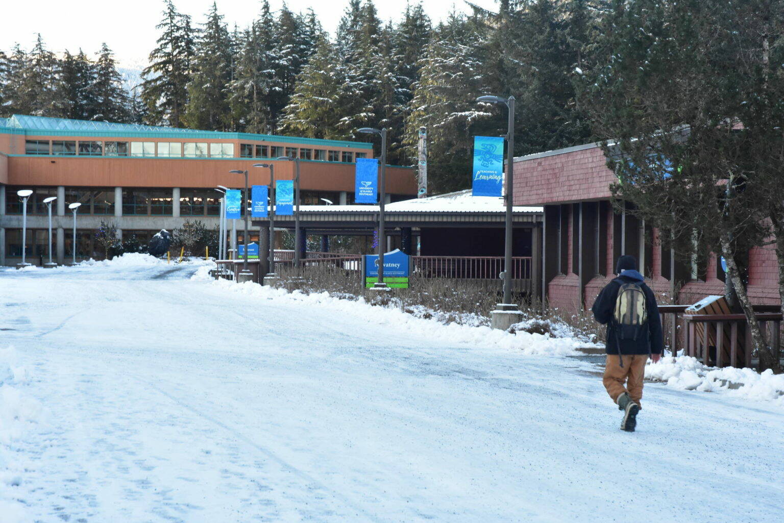 A student walks across the campus of the University of Alaska Southeast in this Feb. 4, 2021 file photo. An Anchorage Superior Court ruled Thursday against a group of UA students who had sued the state over funding for higher education scholarship programs. (Peter Segall / Juneau Empire file)