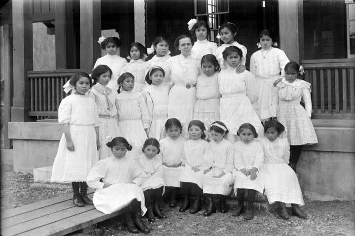 A class photo from the Sitka Industrial Training School ca.<tcxspan tcxhref="18971929" title="Call 1897-1929, via 3CX"> 1897-1929,</tcxspan> shows young Alaska Native women who were taken from their homes are raised in one of Alaska’s boarding schools. This week, the First Alaskans Institute is hosting a summit for survivors and others impacted by the boarding school system. (Courtesy photo / Alaska’s Digital Archives)