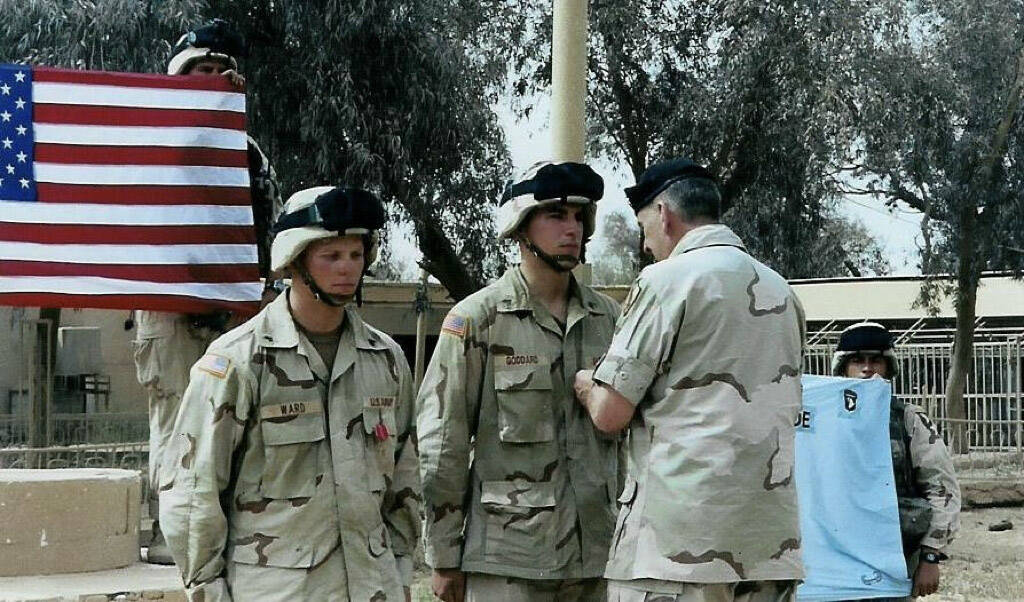 Receiving the Bronze Star with V (Valor) from General Tommy Franks for spearheading the assault on the airport, Najaf, Iraq April 2003. Photo courtesy of Lucas Goddard, (Courtesy Photo / U.S. Army)