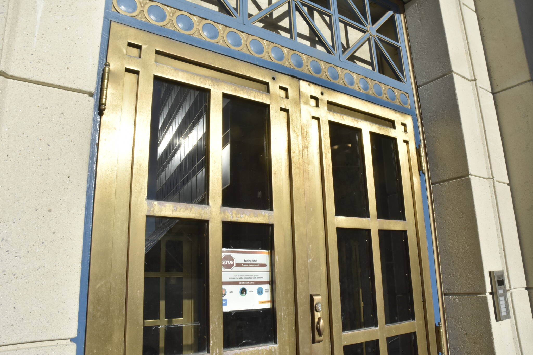 The front doors of the Alaska State Capitol was missing the sign notifying visitors of the building's masking requirement on Wednesday, Feb. 23, 2022, after an early morning by lawmakers changed the rule. Masking rules have been in place since October 2020, much to the consternation of some lawmakers. (Peter Segall / Juneau Empire)